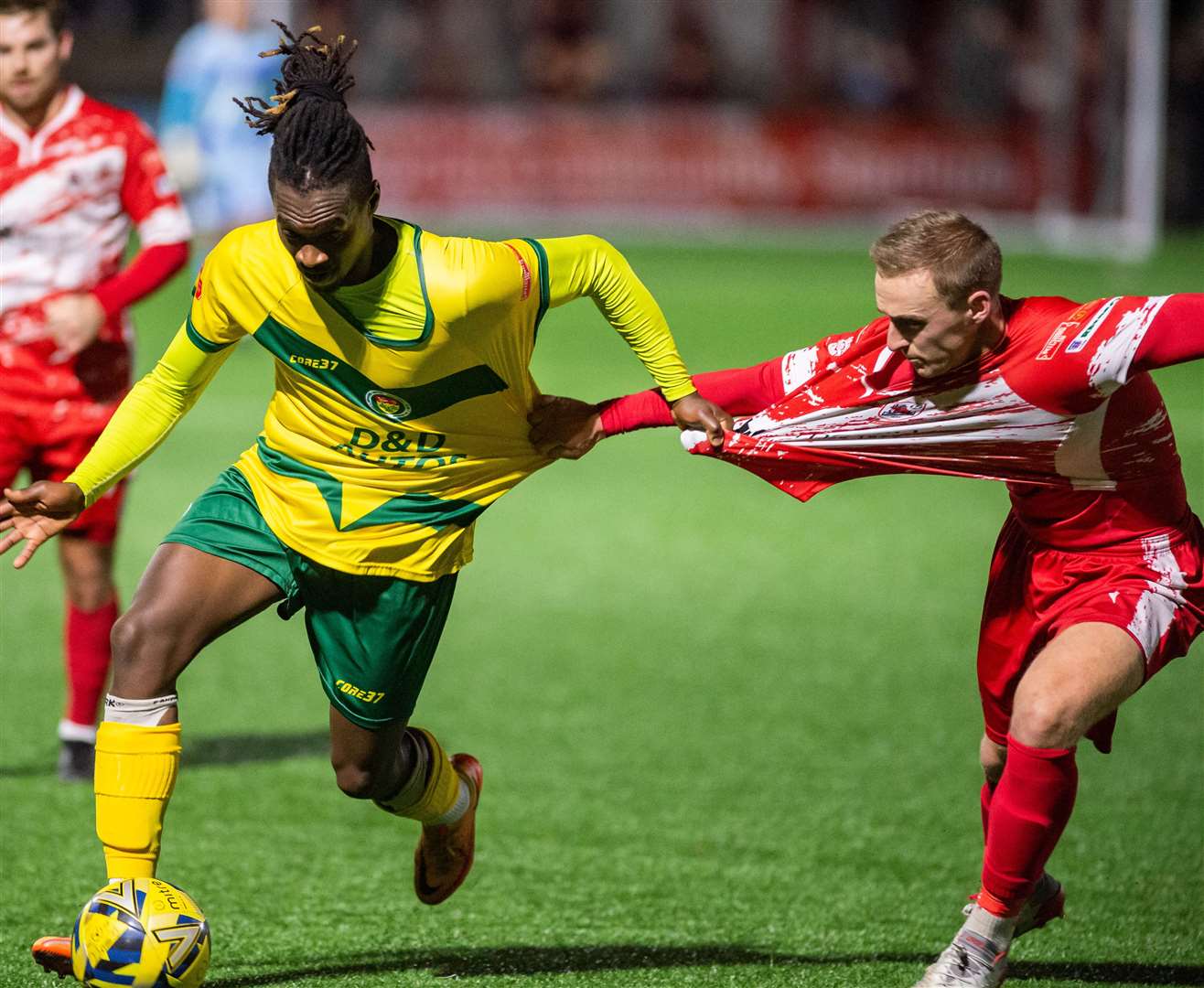 Ashford midfielder Toby Ajala and his marker get to grips with each other. Picture: Ian Scammell