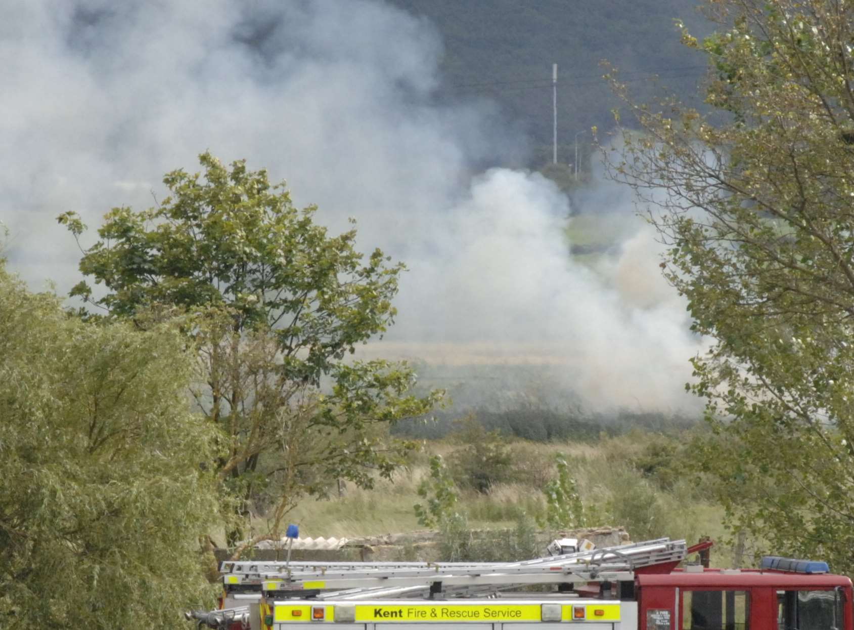 Firefighters battle a grass fire. Stock image