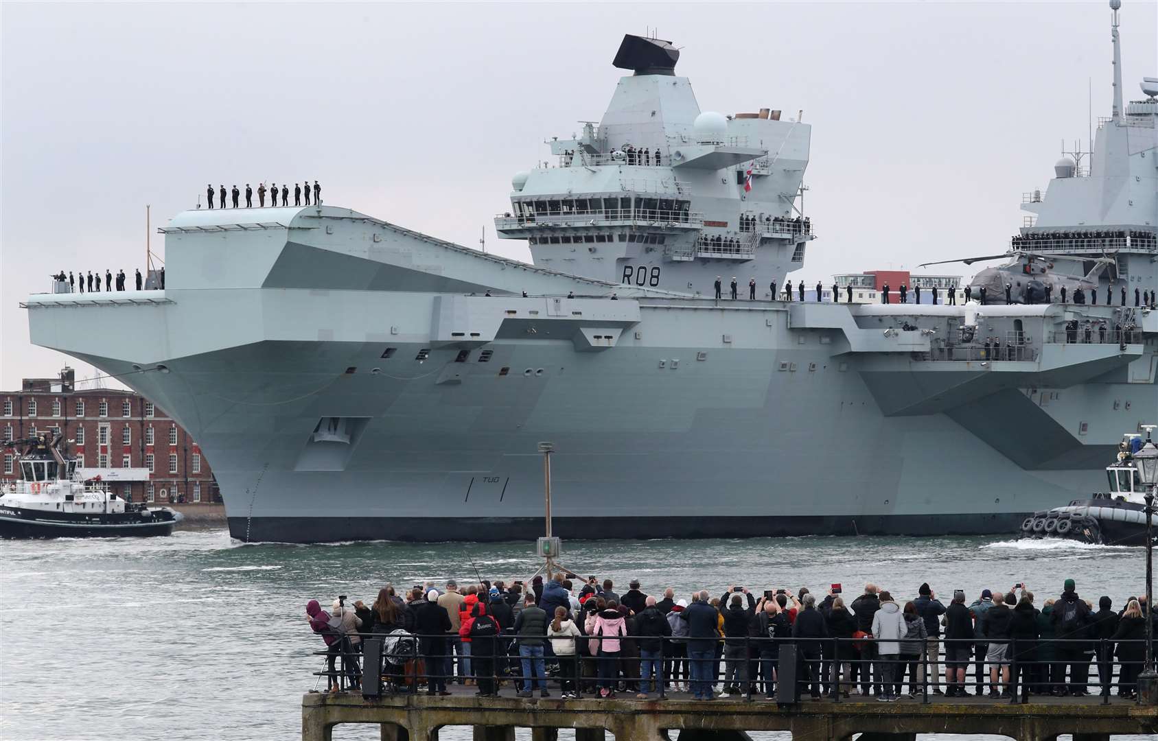 HMS Queen Elizabeth passes the Round Tower as it leaves Portsmouth Naval Base (Andrew Matthews/PA)