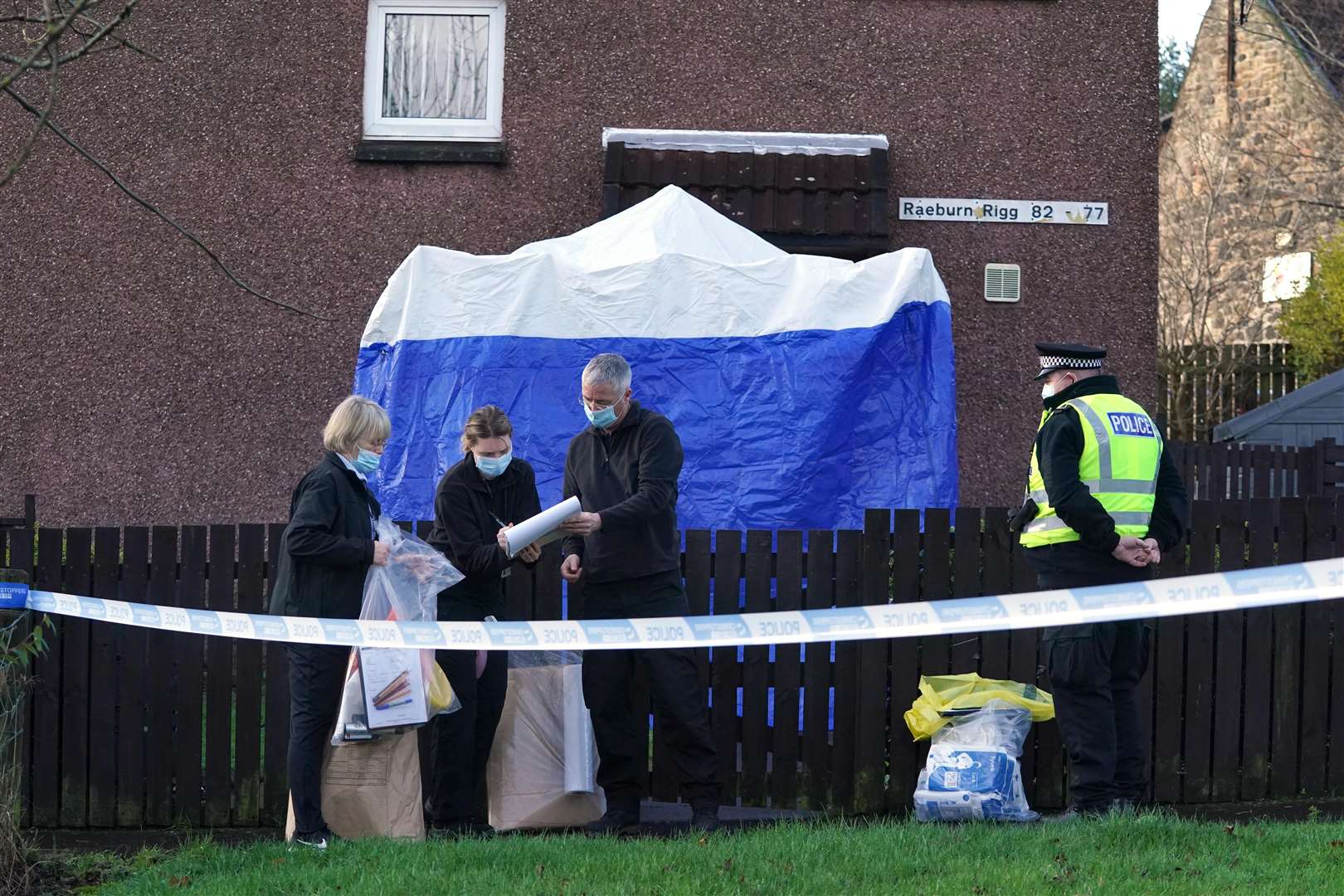 Police at the address in Livingston where the couple were found dead (Andrew Milligan/PA)