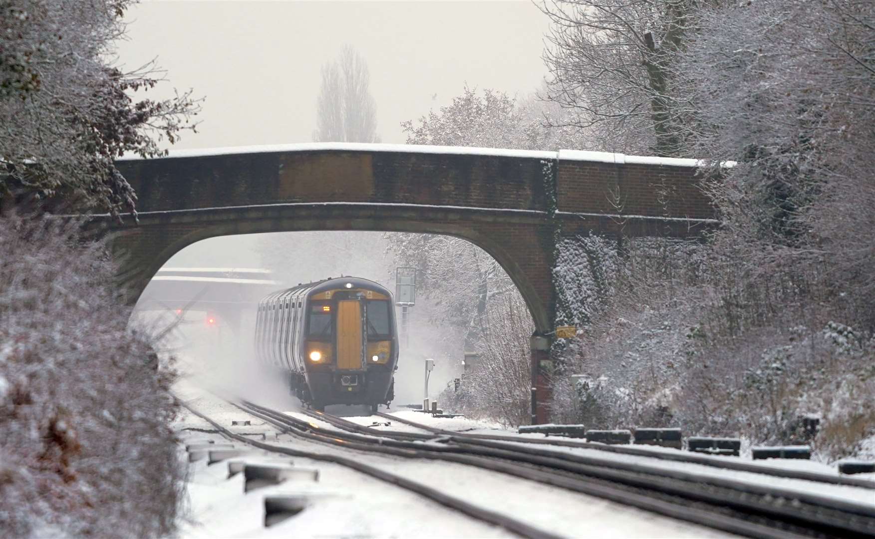 A Southeastern train makes its way through Ashford in Kent as rail services remain disrupted in the icy weather (Gareth Fuller/PA)