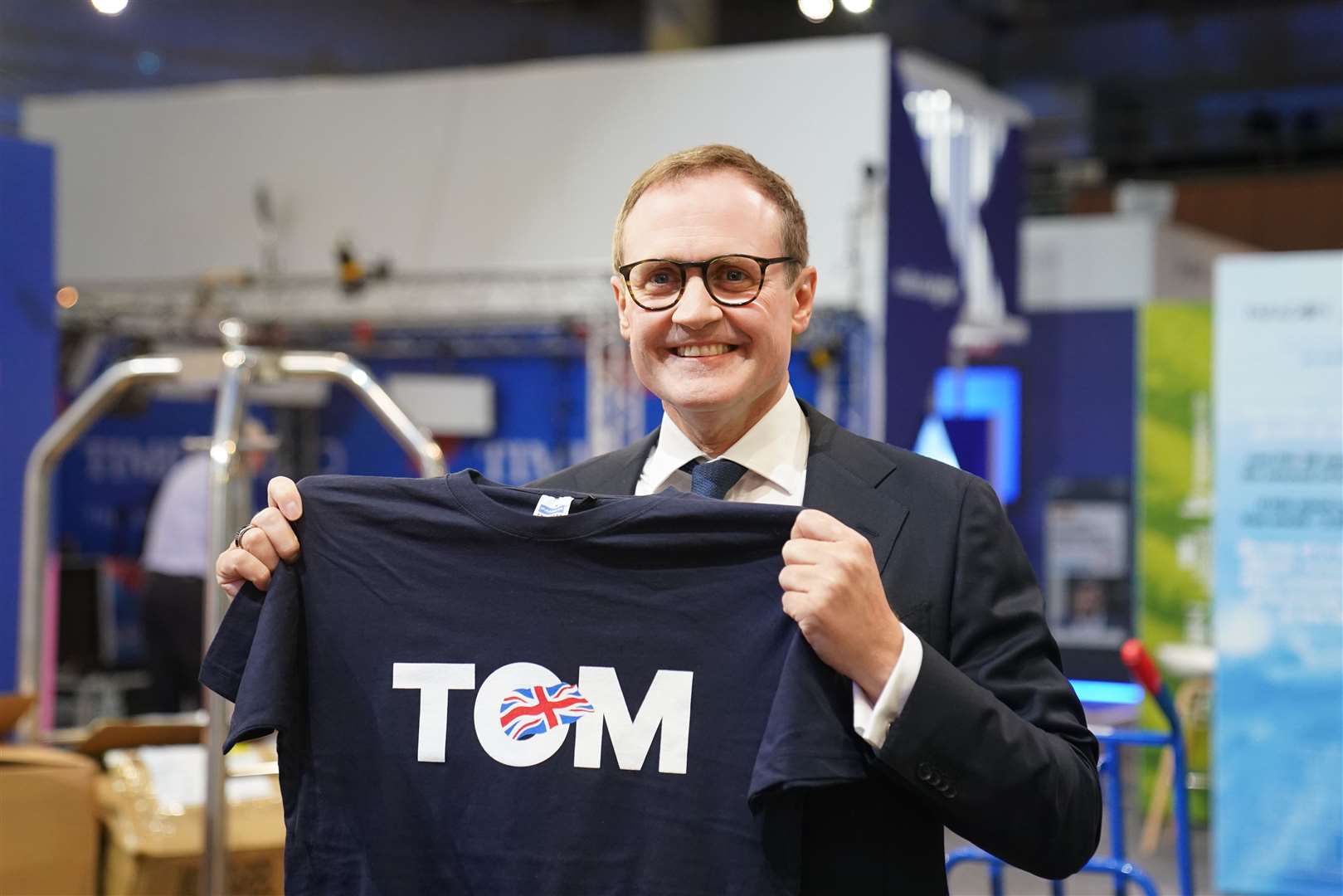 Tom Tugendhat looking at one of his T-shirts during the Conservative Party Conference (Stefan Rousseau/PA)