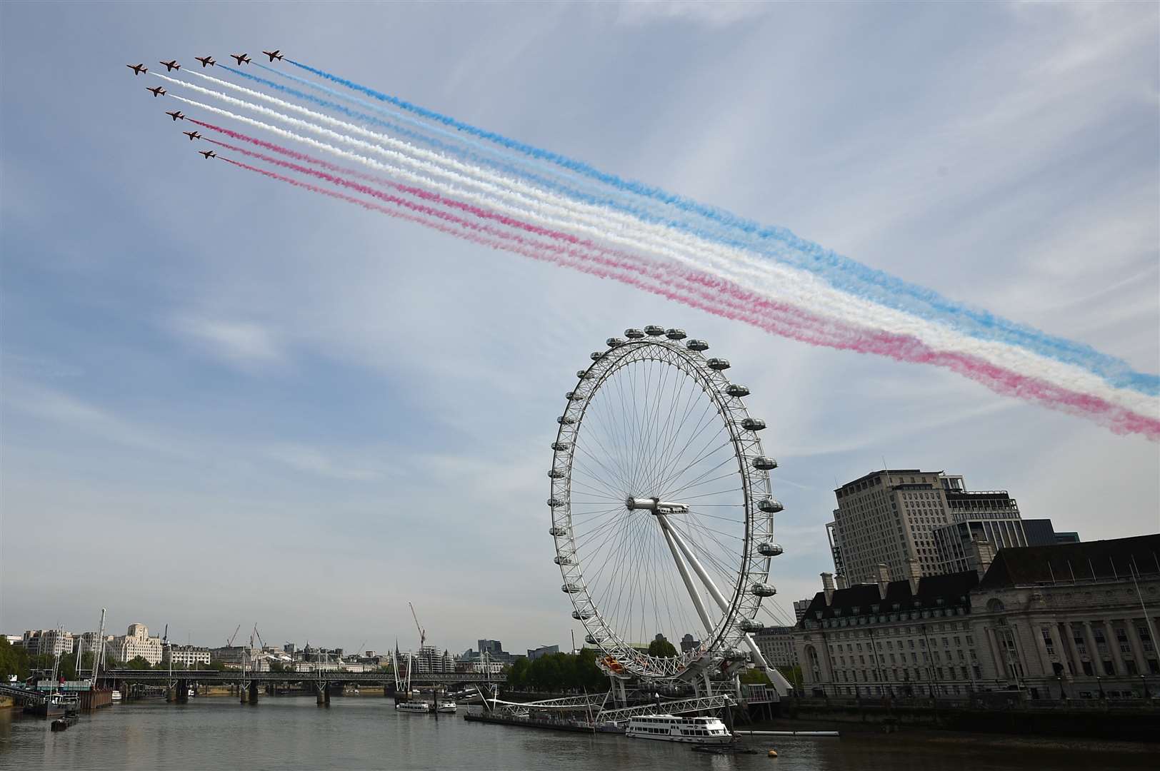 The Royal Air Force Red Arrows pass over the London Eye on the banks of the River Thames (Marc Ward/PA)