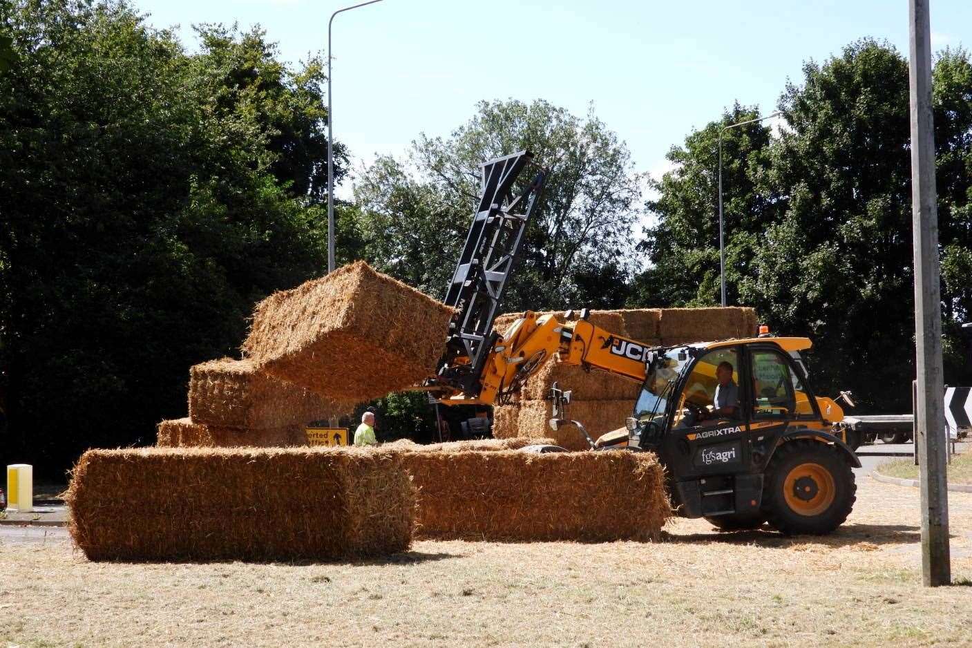 A forklift was used to clear the bales from the road. Picture: Ale Pen