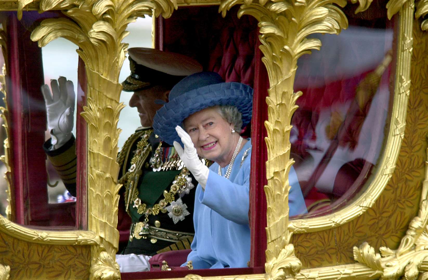 The Jubilee Queen in the Gold State Coach in 2002 (Rebecca Naden/PA)