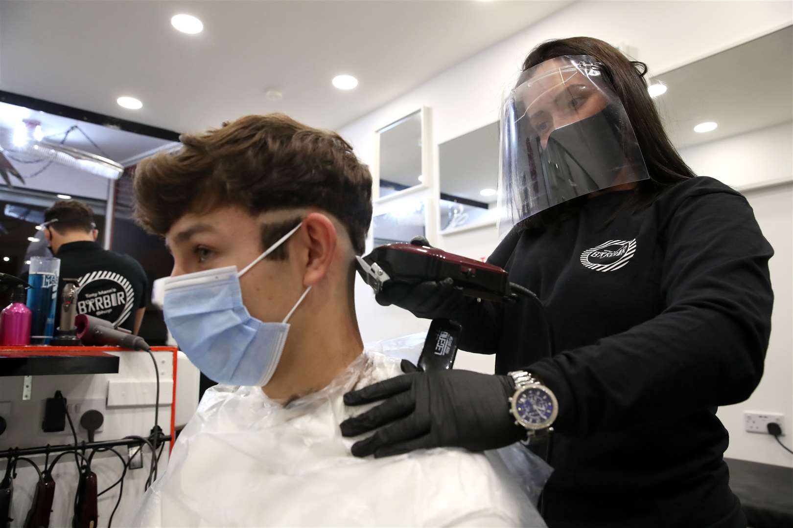 Barber Margaret McGillivray with customer Mitchell Wildman (Andrew Milligan/PA)