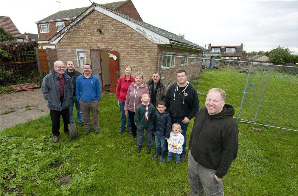 Mat Jeffery (right) and the other members of the group outside the scouts hall which is having new fencing, windows and a driveway