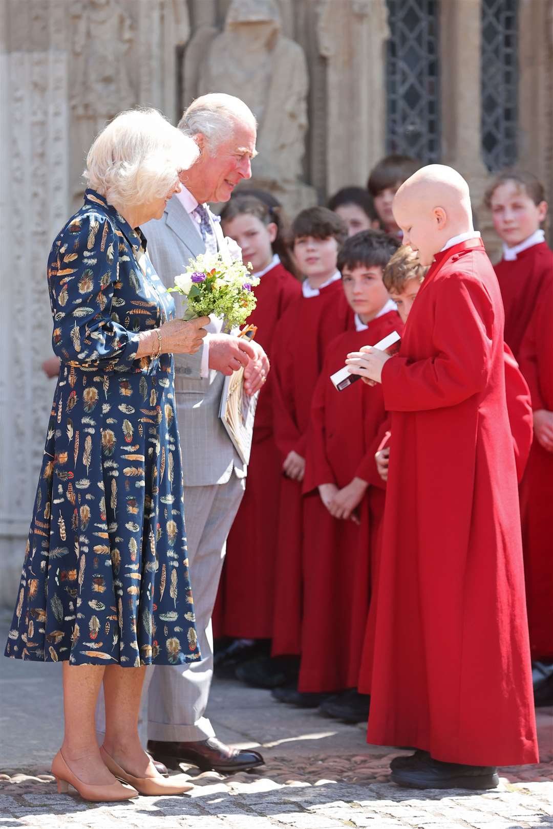 Chorister James Mason-Carney presents the prince with a copy of the book he illustrated called Tiggs and the Midnight Choir (Chris Jackson/PA)