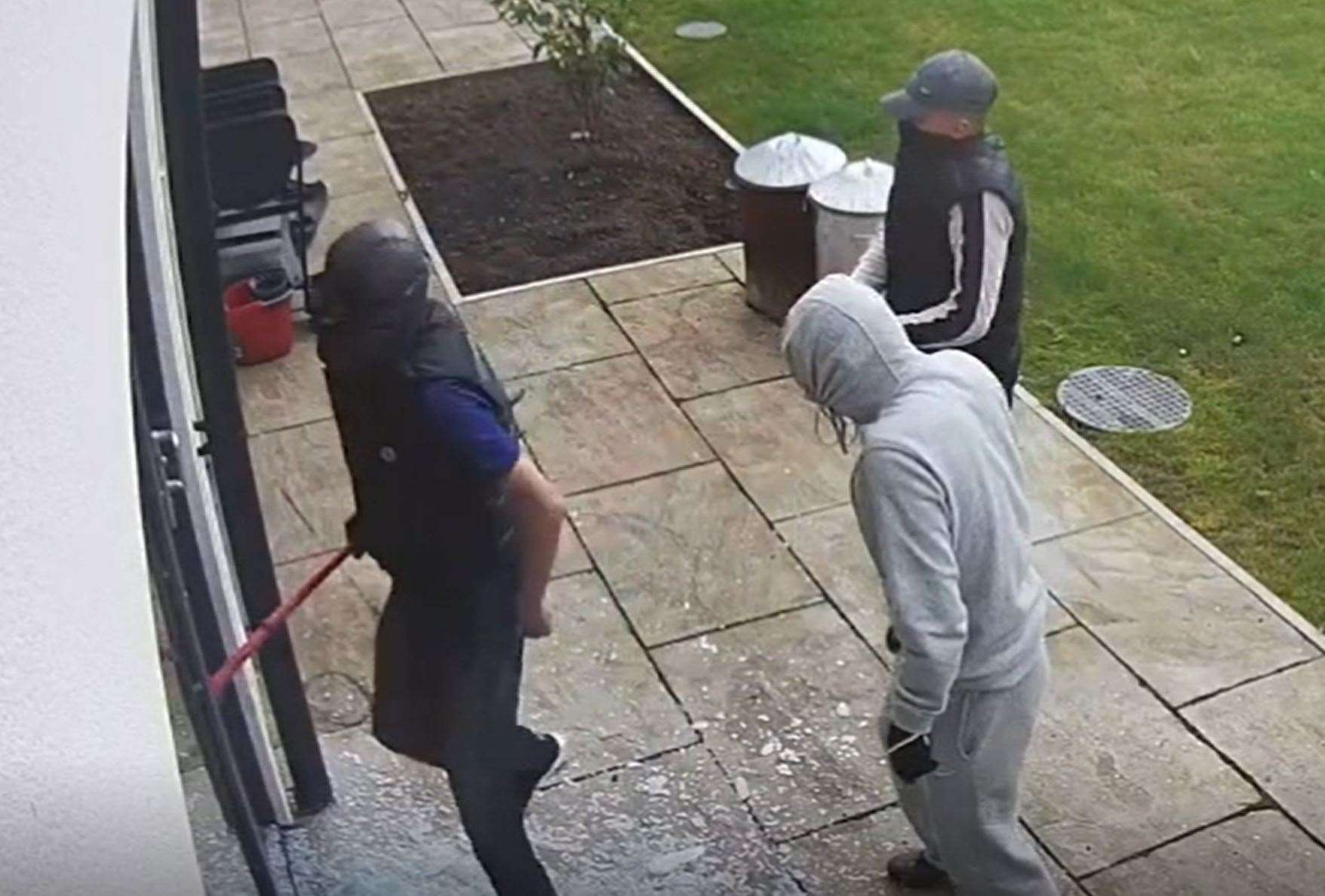 Screen grab from handout footage of Daniel Flynn (sleeveless, left) during a burglary of the home of Cardiff City footballer Sol Bamba (South Wales Police/PA)