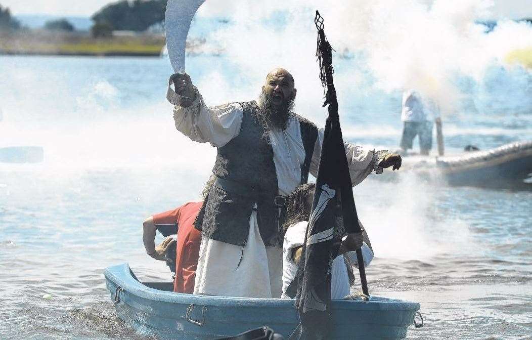 Captain Cutlass leads the Sheppey Pirates as they invade Barton's Point Coastal Park, Sheerness, during a junior pirates day