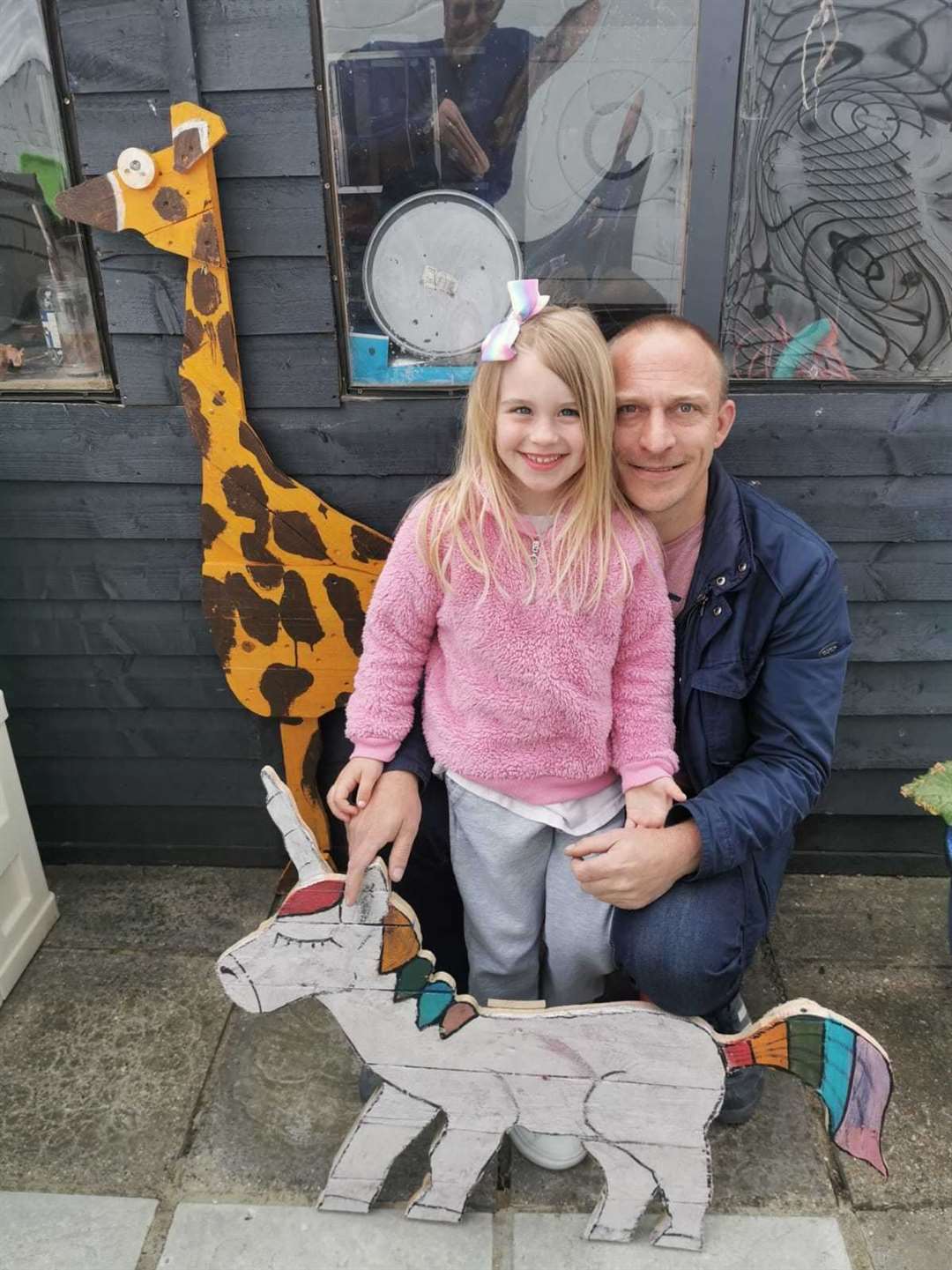 John Wenham and daughter Penny with her giraffe and unicorn creations