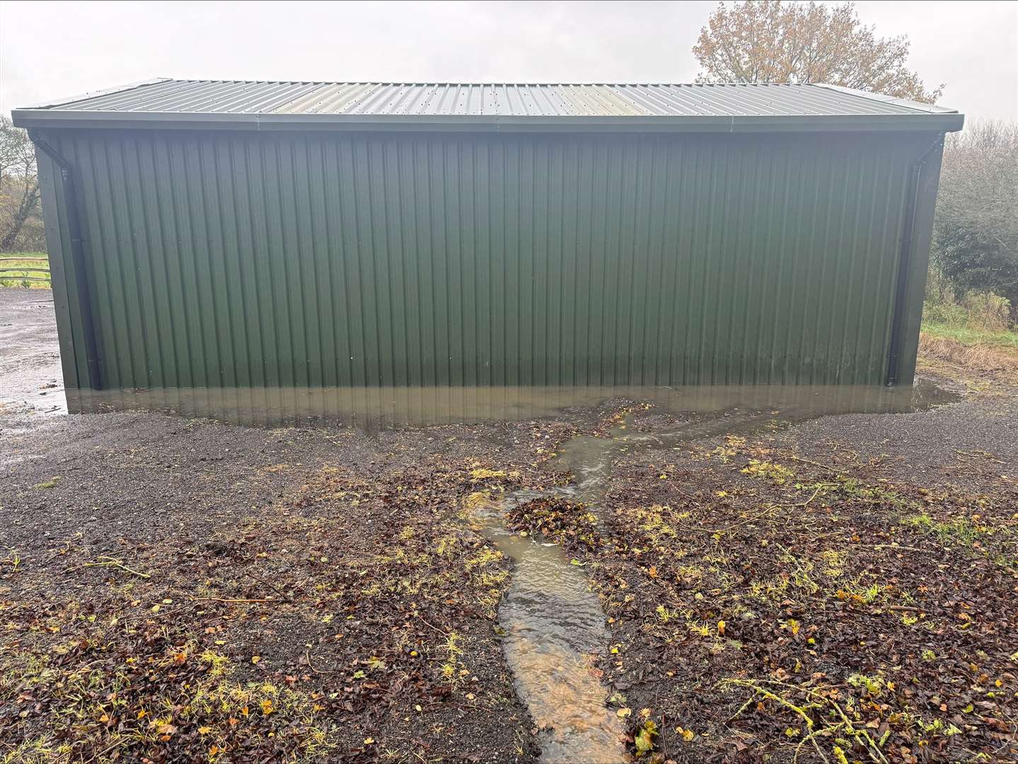 The sewage cut a channel across Alan Dean's farmyard and pooled around his barn