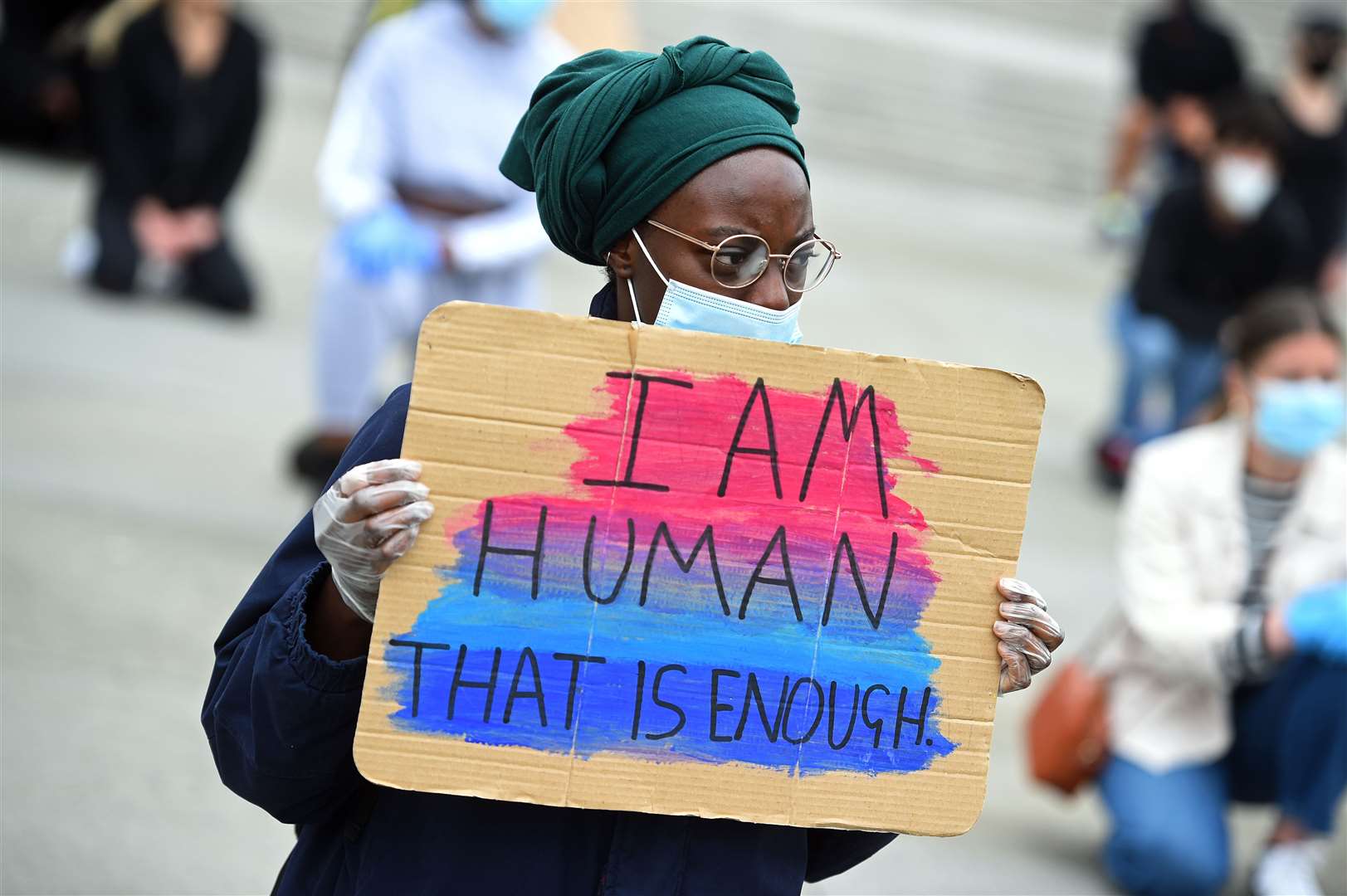 A woman takes part in the kneeling protest in Trafalgar Square (Kirsty O’Connor/PA)