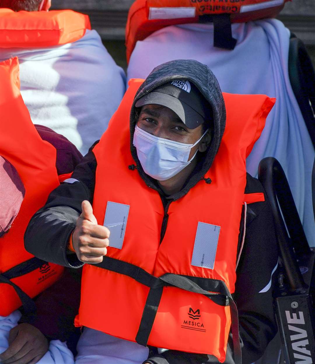 A man, thought to be a migrant, gives a thumbs as he is brought in to Dover, Kent, by Border Force (Steve Parsons/PA)