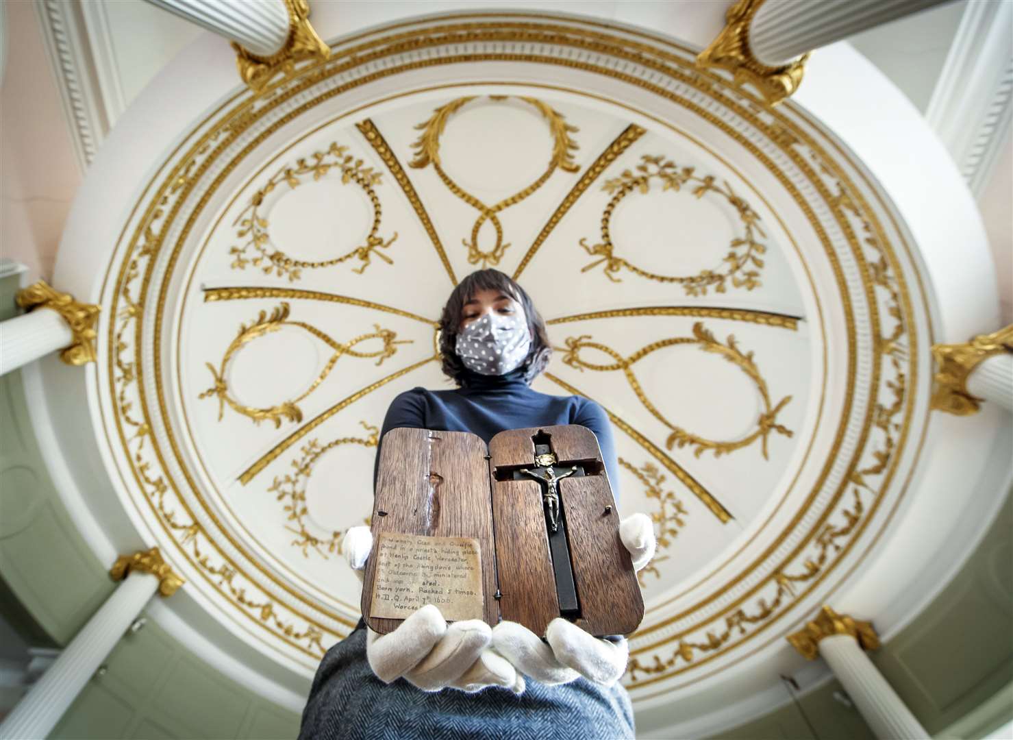 Special collections manager Dr Hannah Thomas holds Blessed Edward Oldcorne’s crucifix at the Bar Convent in York (Danny Lawson/PA)