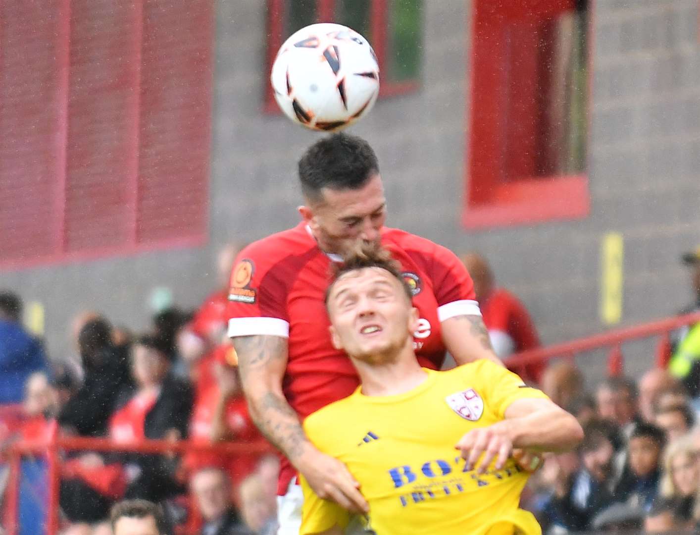 Ebbsfleet United defender Lewis Page wins an aerial battle in the first half of their 3-0 National League home loss to Woking. Picture: Ed Miller / EUFC