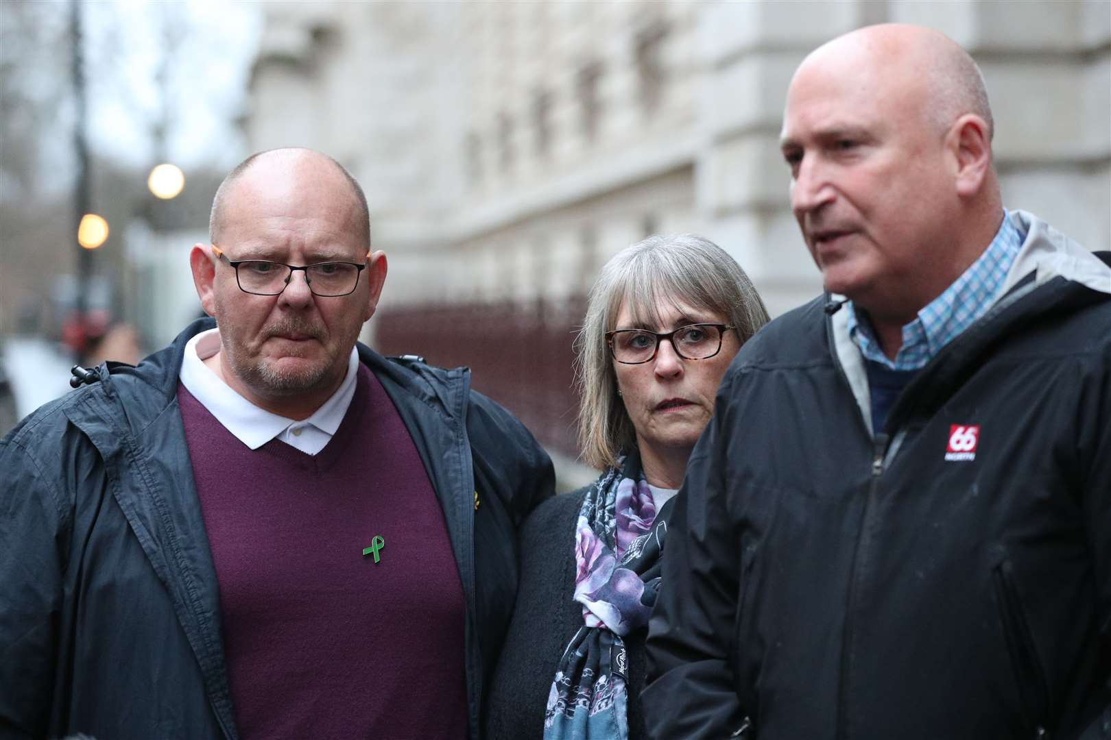 Tim Dunn with his wife Tracey and family spokesman Radd Seiger (Jonathan Brady/PA)