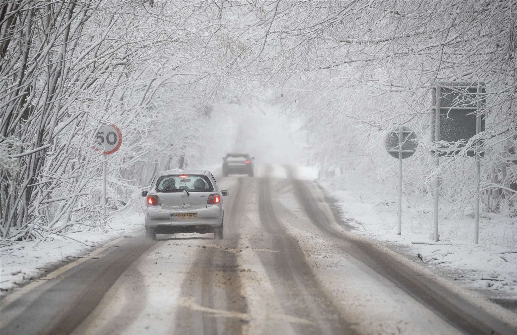 A car makes its way along a snow-covered A252 near Charing in Kent (Andrew Matthews/PA)