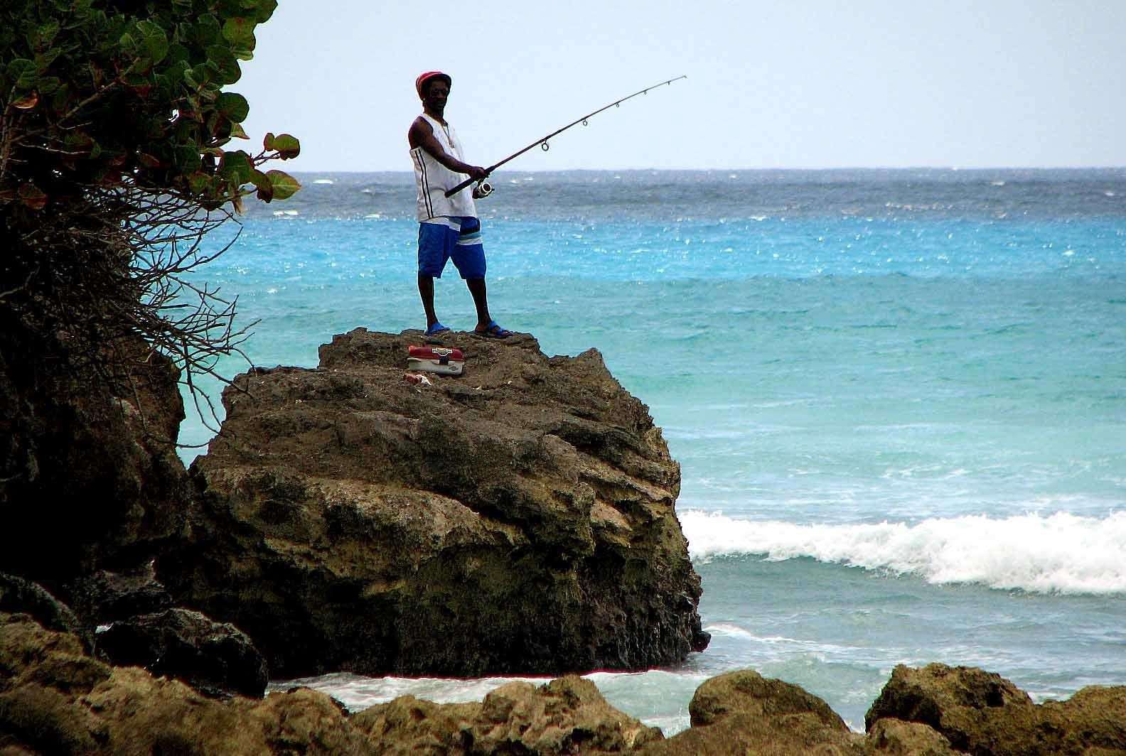 A fisherman at Rockley Beach, Christchurch, Barbados (Rui Vieira/PA)