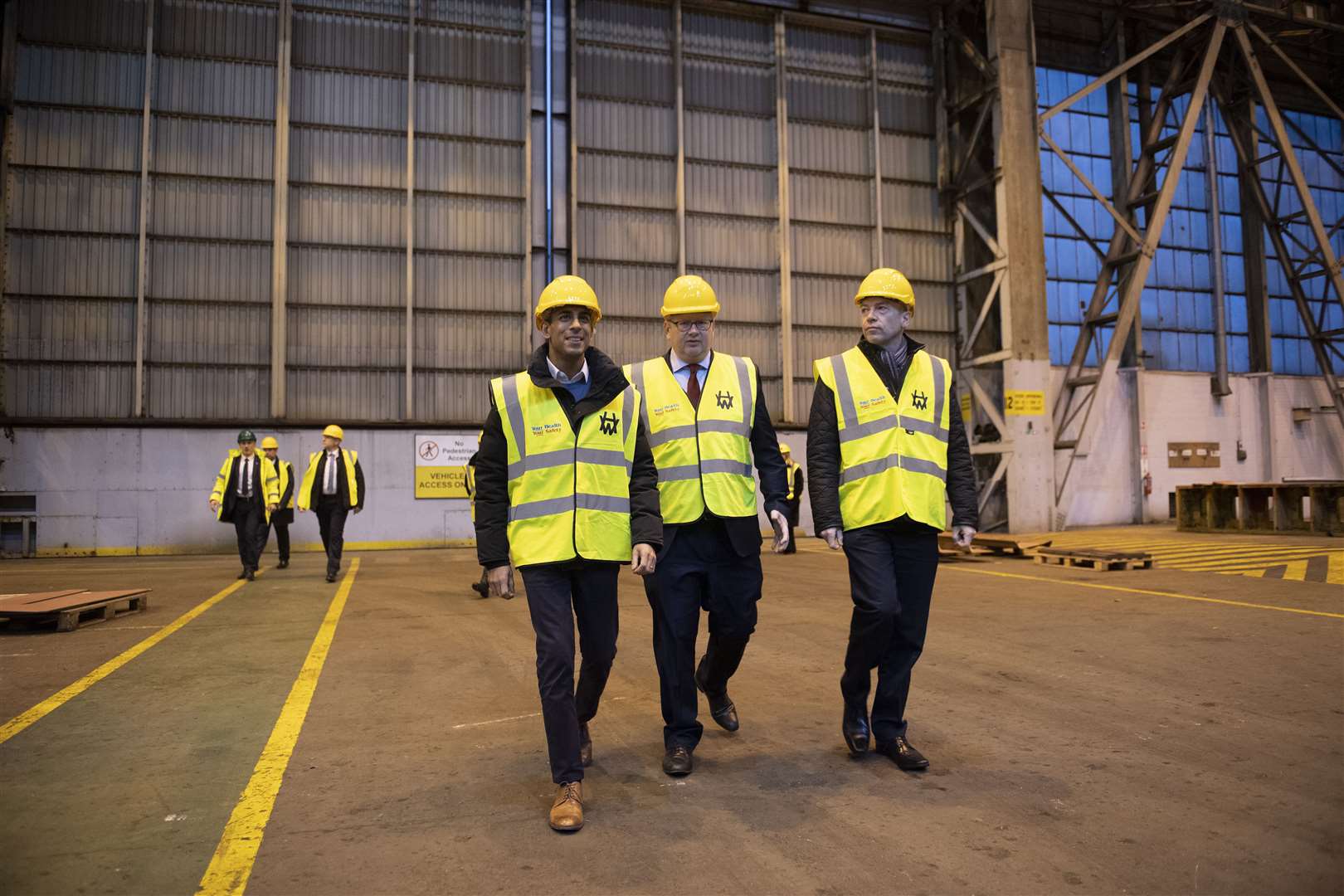 Prime Minister Rishi Sunak, left, John Wood of Harland and Wolff, centre, and Northern Ireland Secretary Chris Heaton-Harris check progress at the yard in December (Charles McQuillan/PA)