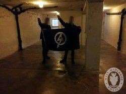 Mark Jones and another man giving a Nazi salute in the execution room at the site of the Buchenwald nazi death camp in Germany (West Midlands Police/PA)