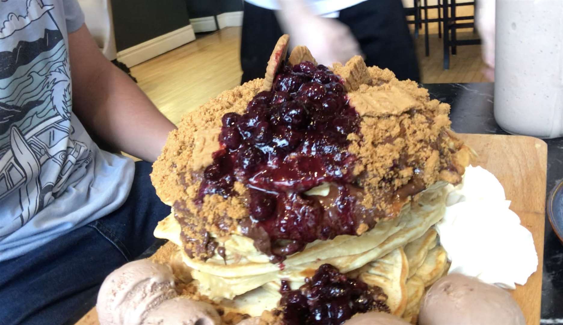 The stack is comprised of 10 American style pancakes and a garnish of chocolate and berries