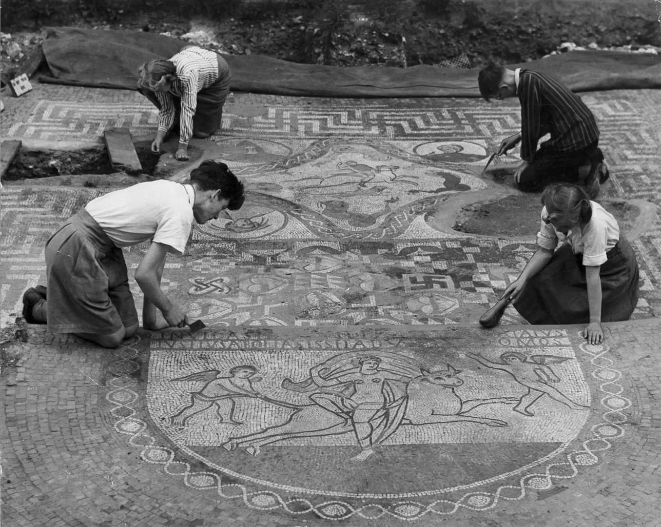 A photo from 1950 shows work being undertaking on the mosaic of the floor of a Roman villa dining room in Lullingstone
