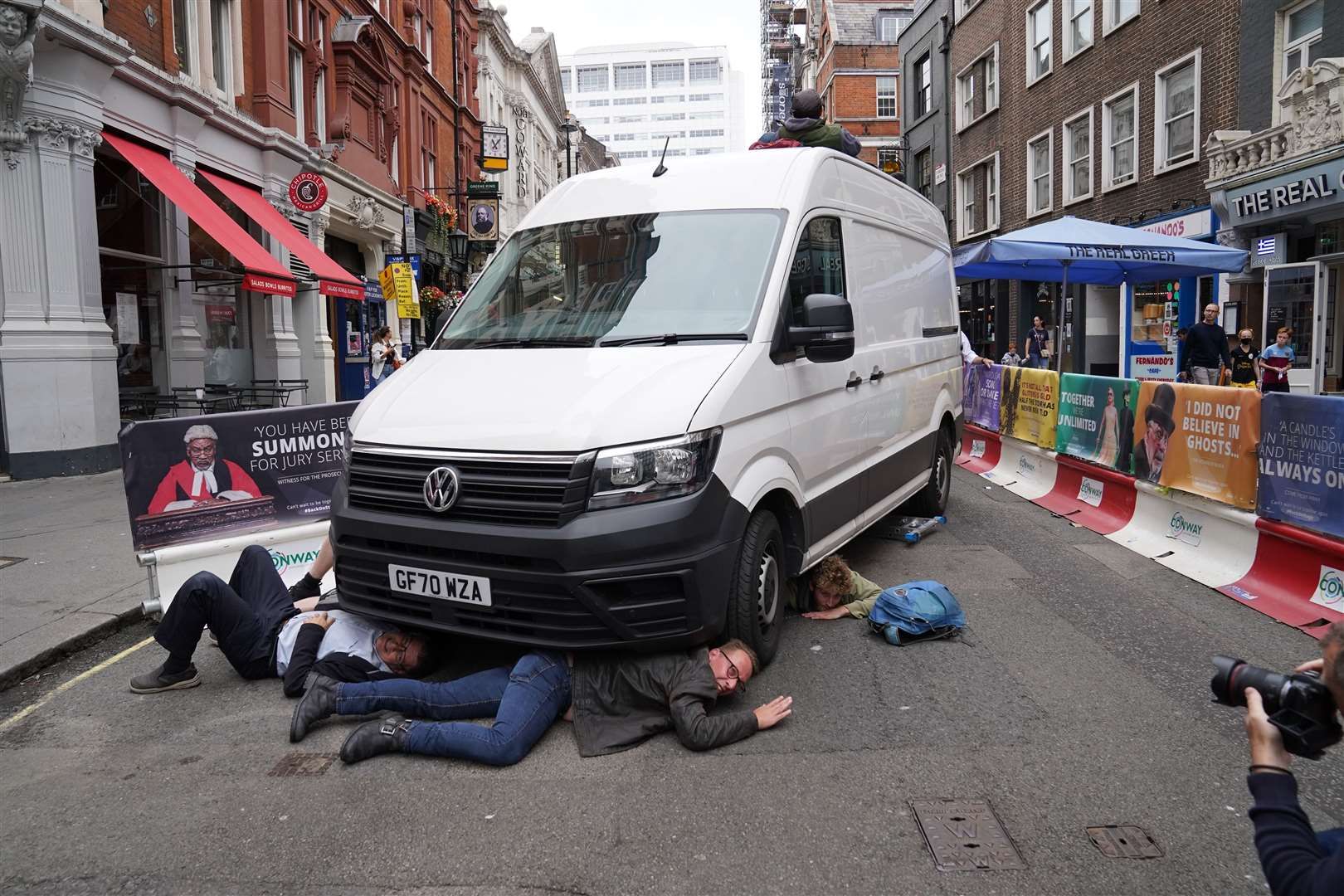 Demonstrators position themselves under a van near Covent Garden (Stefan Rousseau/PA)