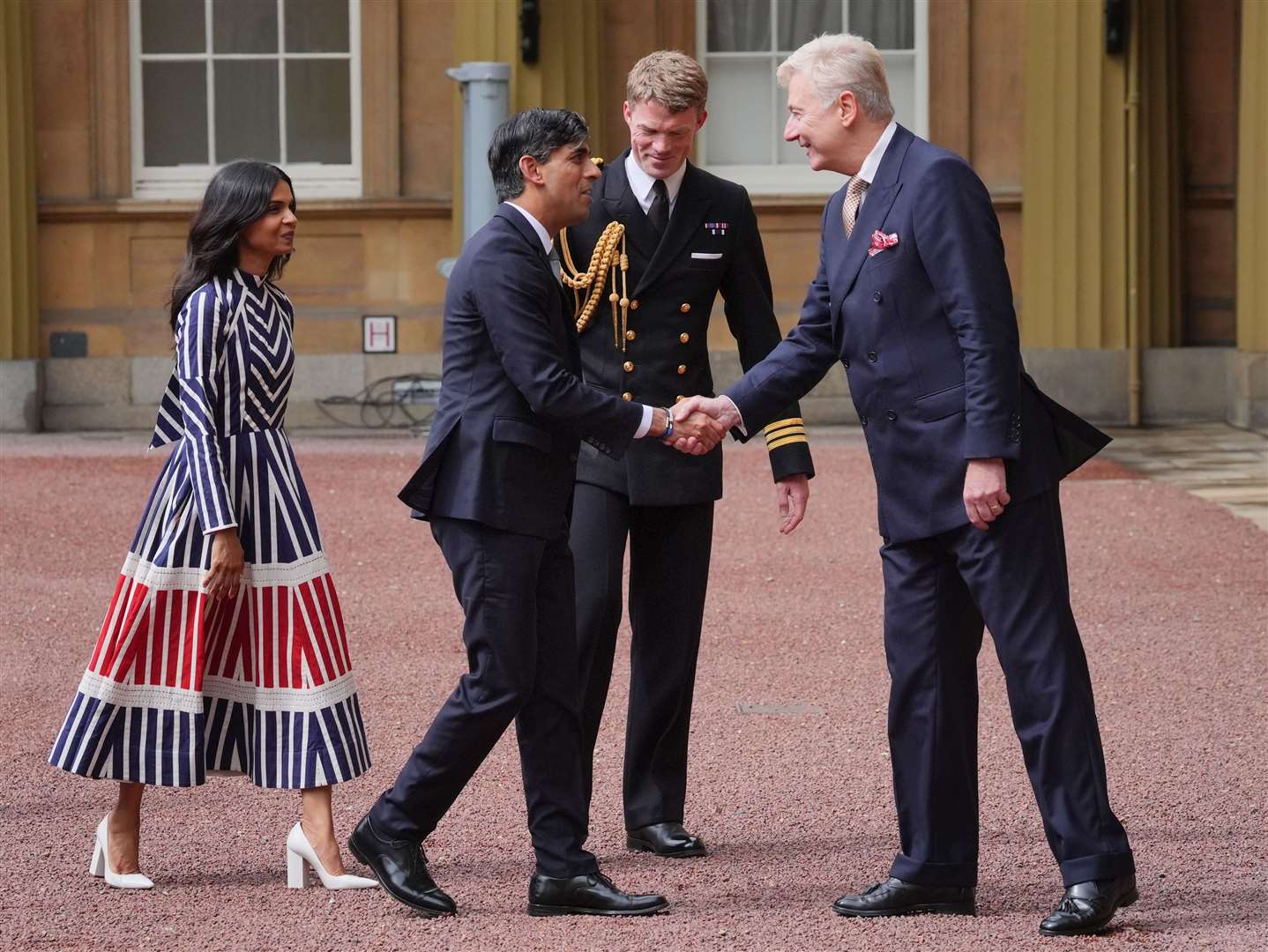 Sir Clive Alderton, principal private secretary to the King, greets Rishi Sunak and his wife Akshata Murty at Buckingham Palace (Jonathan Brady/PA)