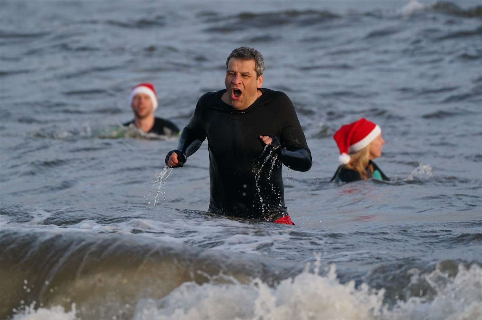 Swimmers tried to forget the chill as they took a Christmas Day dip (Andrew Milligan/PA)