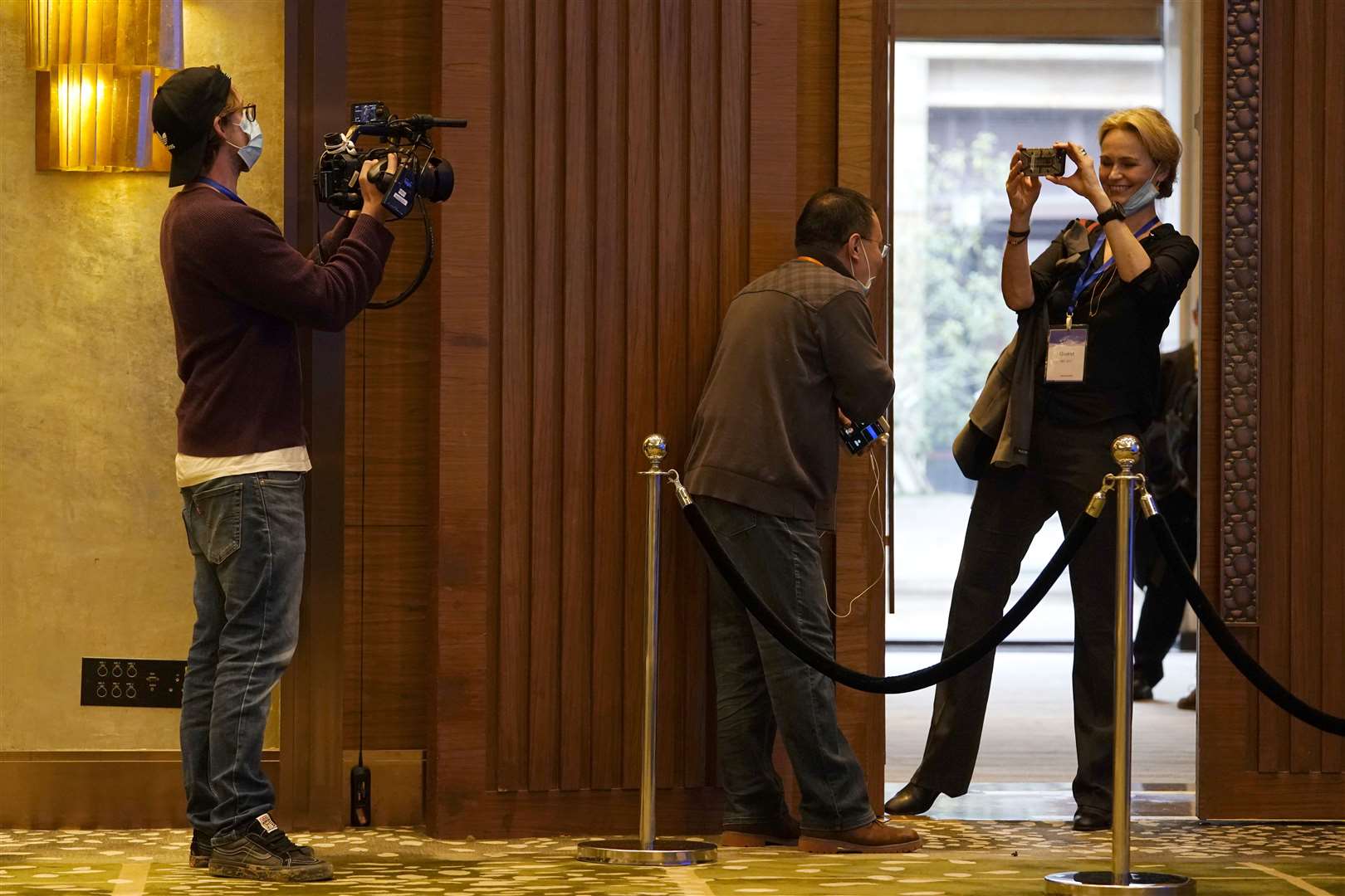 Thea Fischer of the World Health Organisation team takes a photo of the room where a joint press conference was held at the end of the WHO mission in Wuhan (Ng Han Guan/AP)