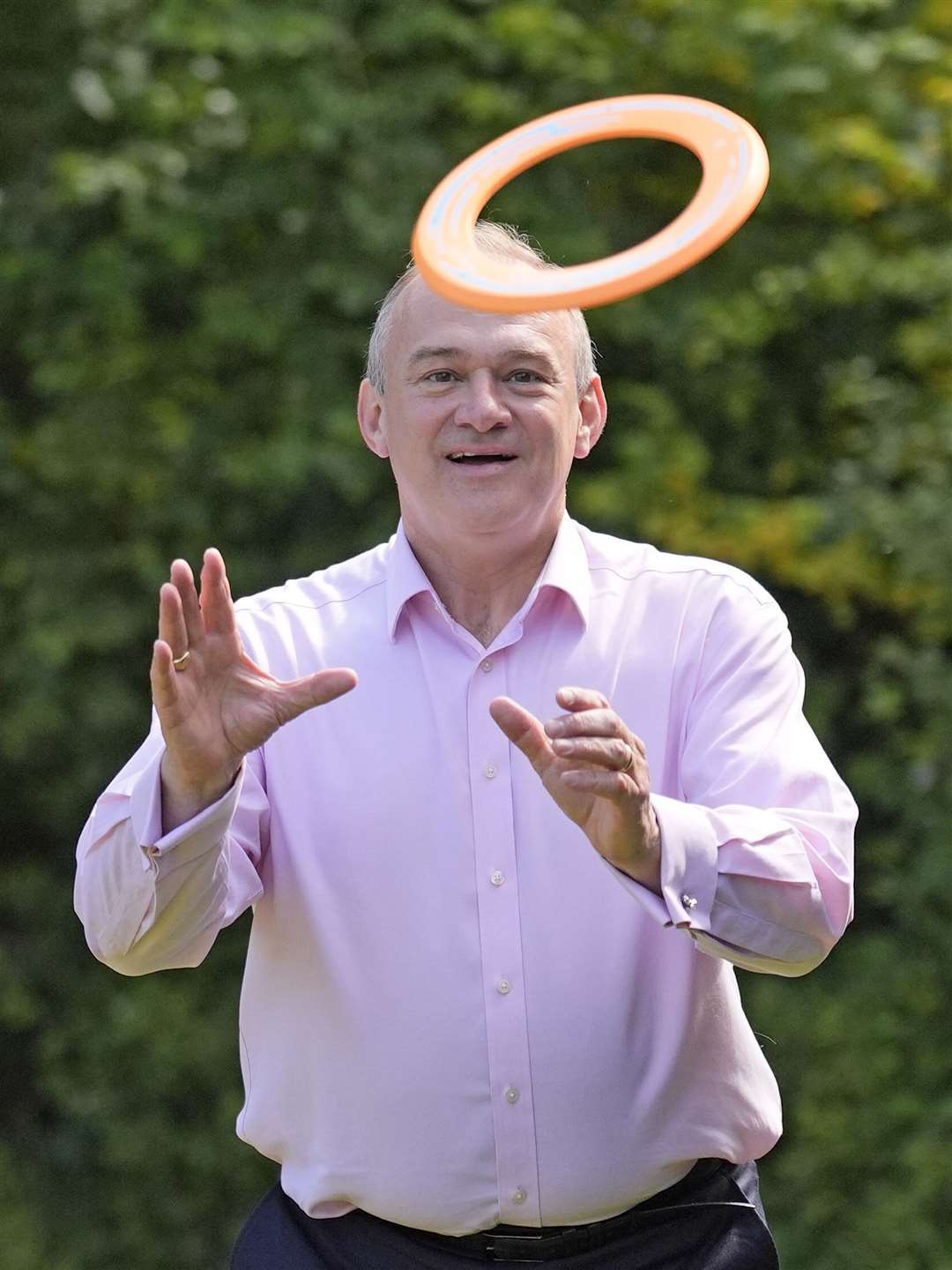 Lib Dem leader Sir Ed Davey plays with a frisbee during a visit to Crowd Hill Farm, in Hampshire (Andrew Matthews/PA)