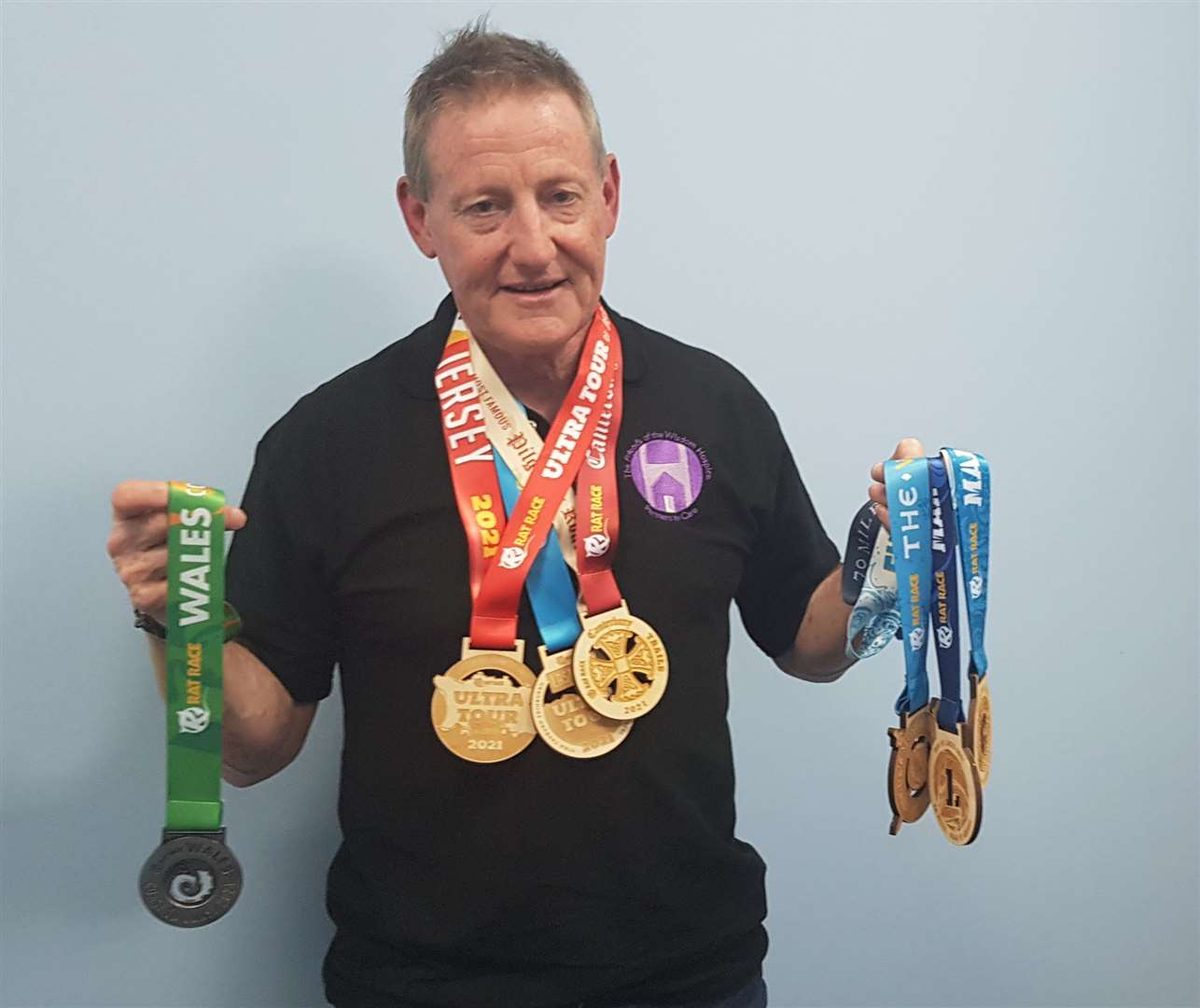 Andy Gray with a collection of the medals he has earned this year when taking on gruelling challenges. Picture: KM