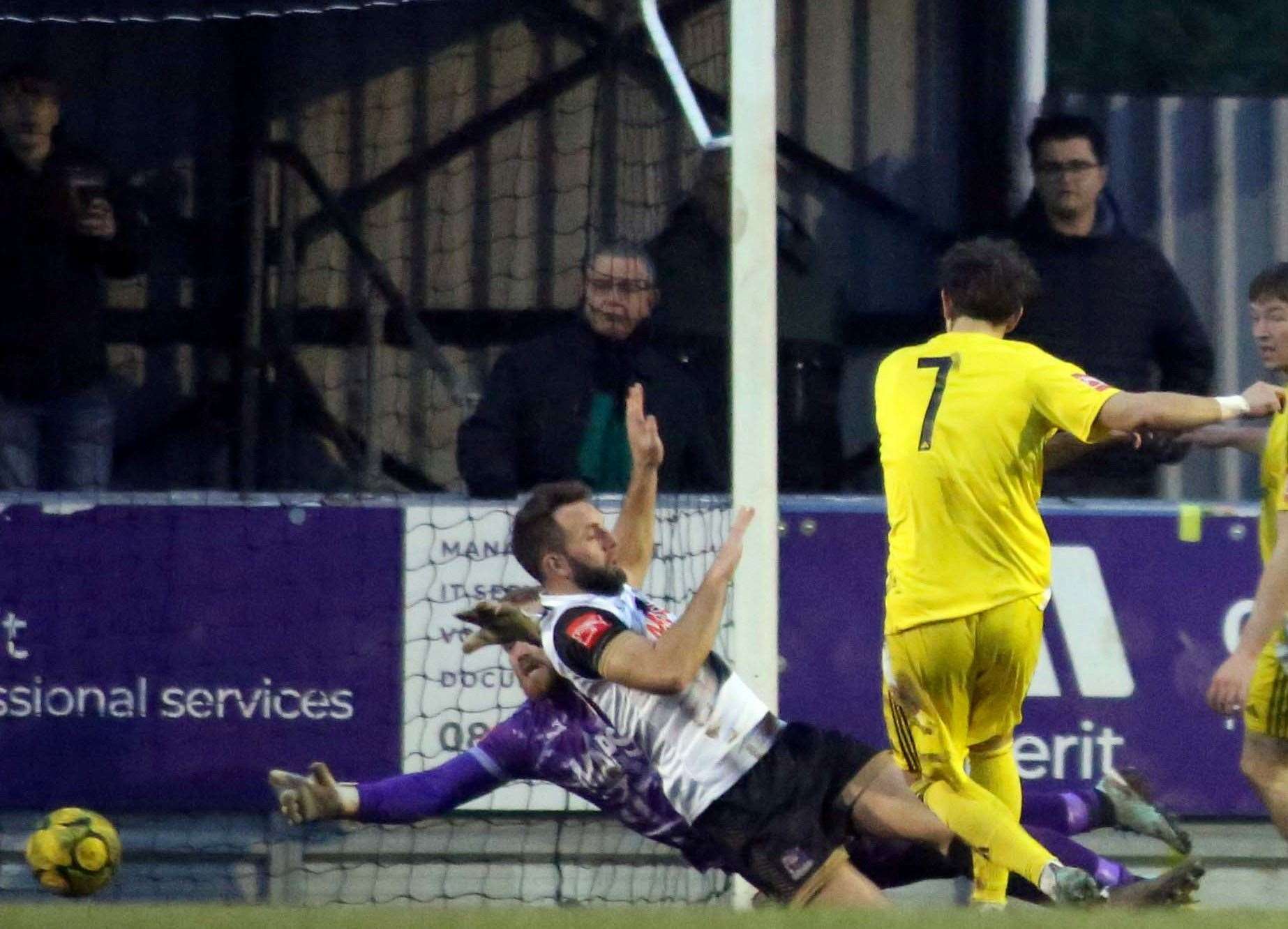 Burgess Hill's Stefan Vukojie fires past Deal Town defender Josh Vincent and goalkeeper Adam Molloy to score. Picture: Paul Willmott