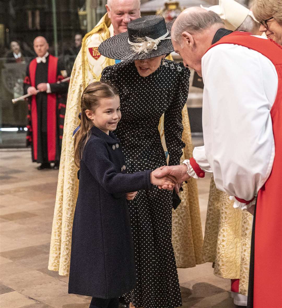 Princess Charlotte is introduced to clergy in Westminster Abbey by her mother (Richard Pohle/The Times/PA)