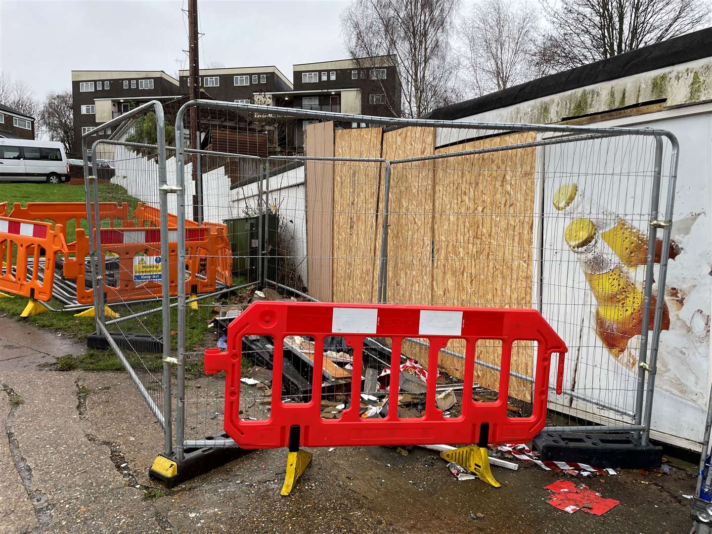 The side of the shop has been boarded up and fenced off