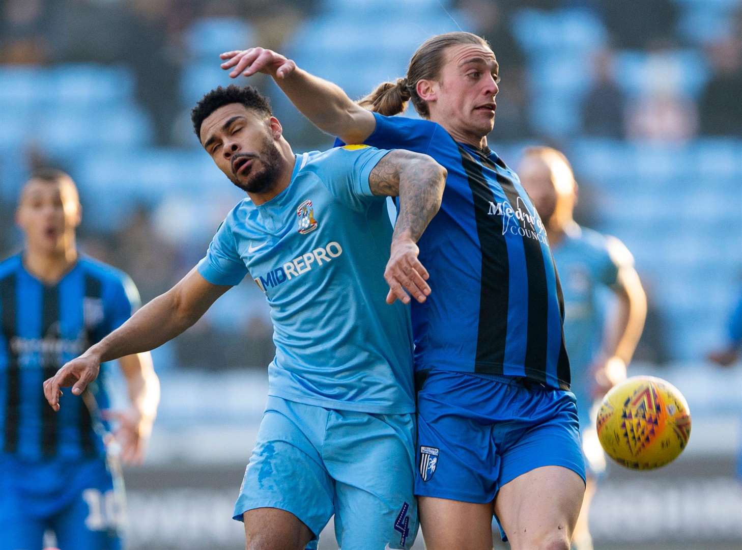 Gills striker Tom Eaves tangles with Jordan Willis Picture: Ady Kerry