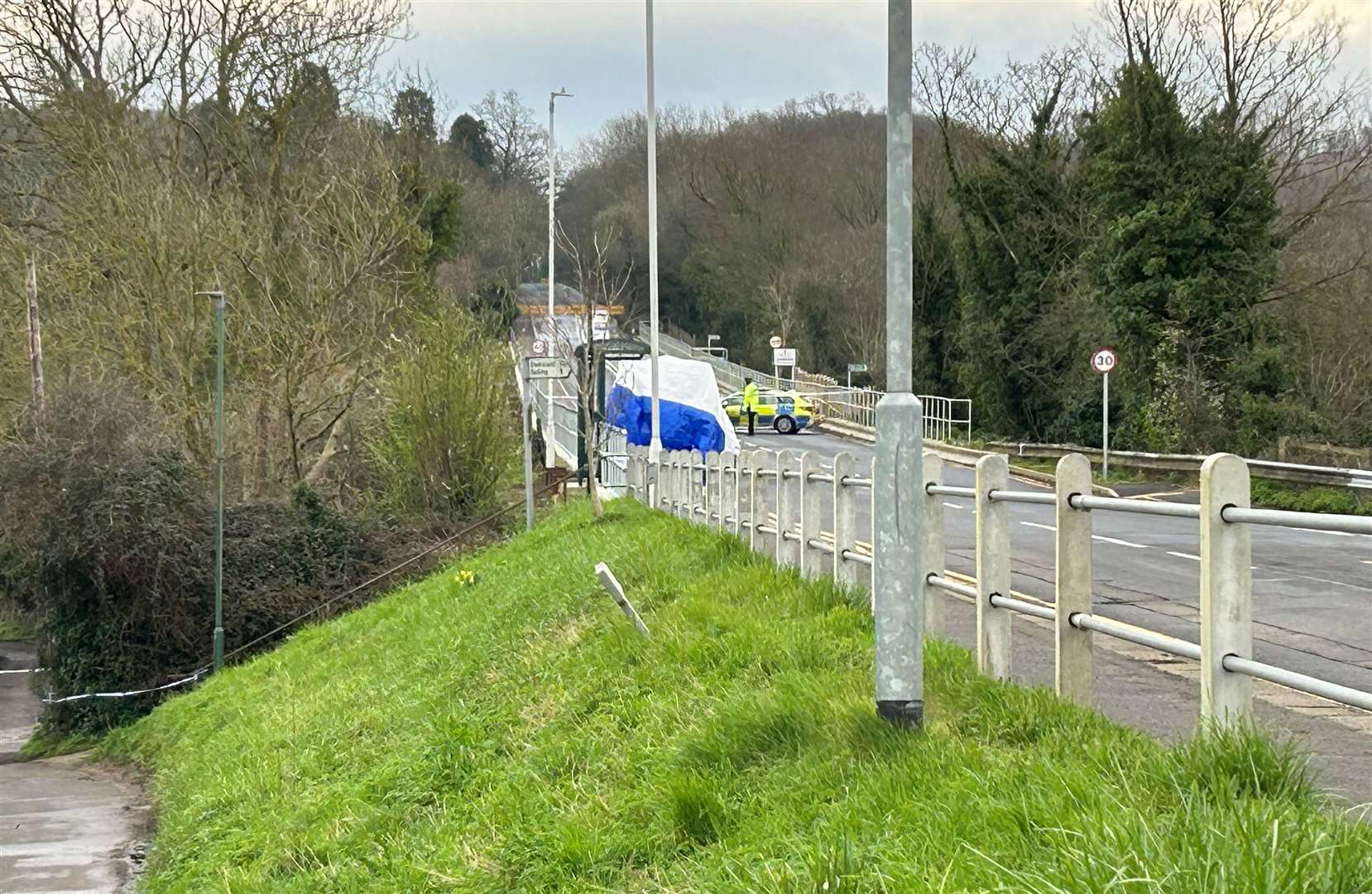 A white tent was erected near a bus stop in the village where Mr Pritchard was treated by paramedics