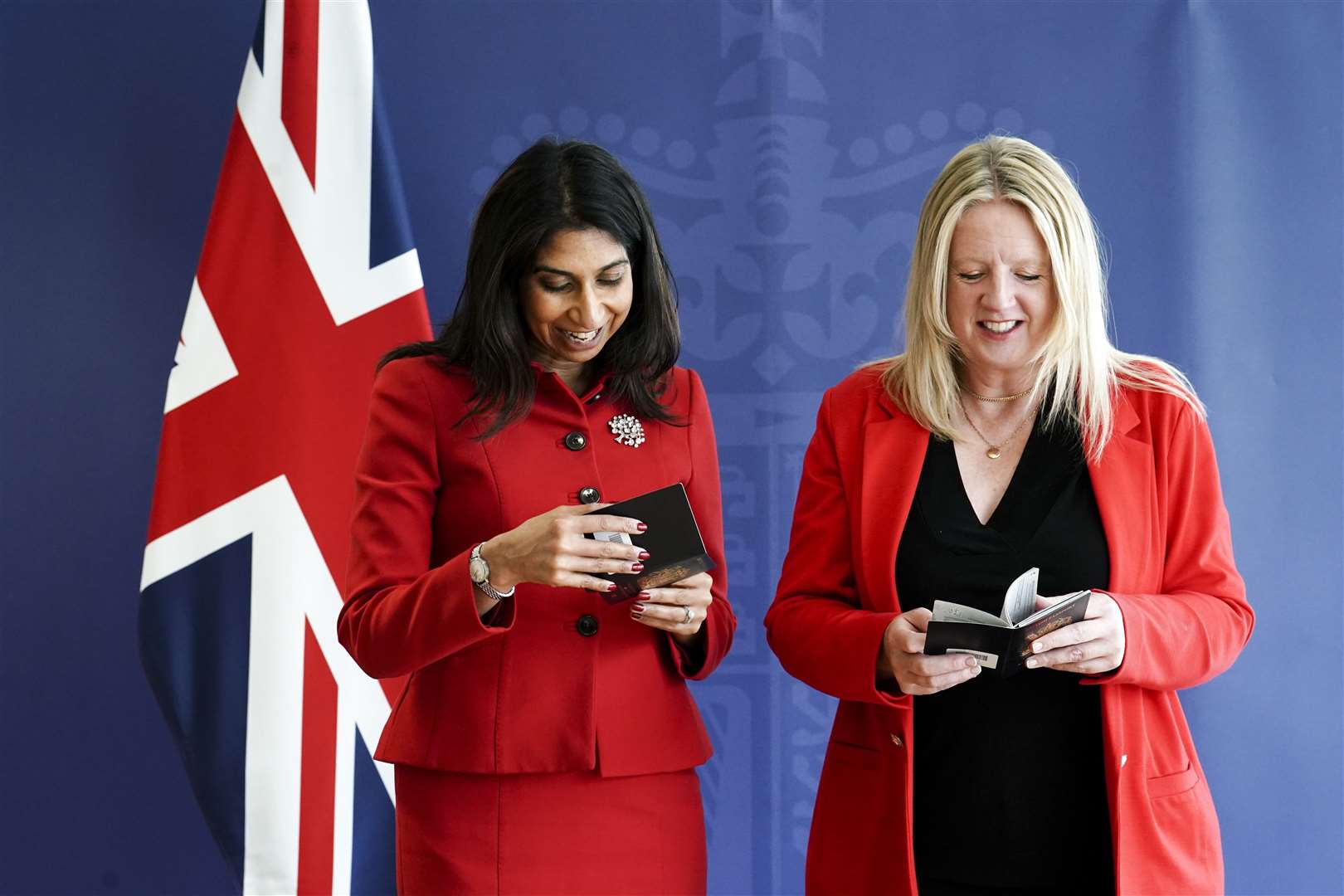 Suella Braverman and Abi Tierney, director general of HM Passport Office and UK Visas and Immigration, with the new passports (Jordan Pettitt/PA)