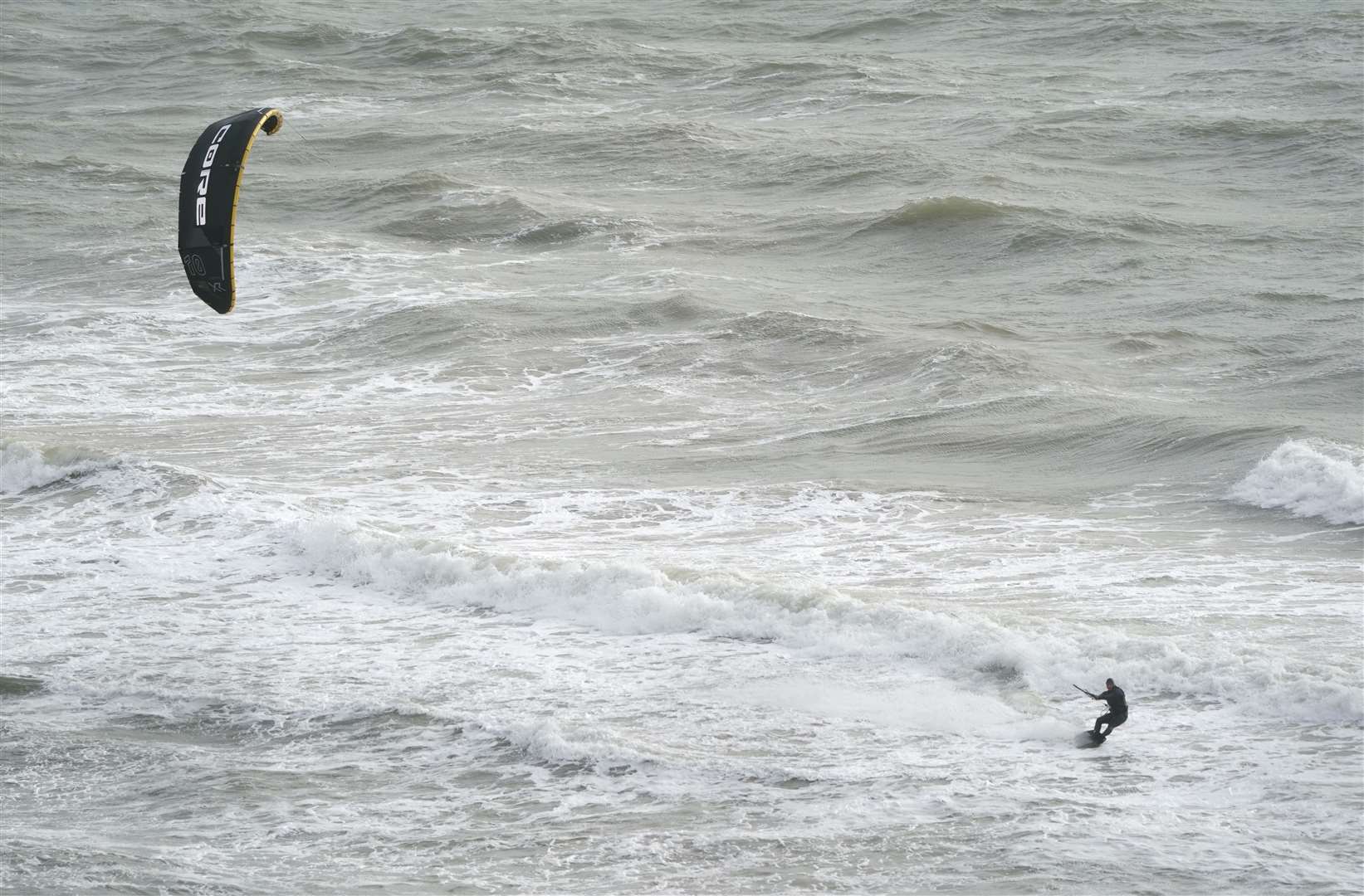 A person kitesurfs in the sea at Boscombe beach in Dorset on Sunday (Andrew Matthews/PA)