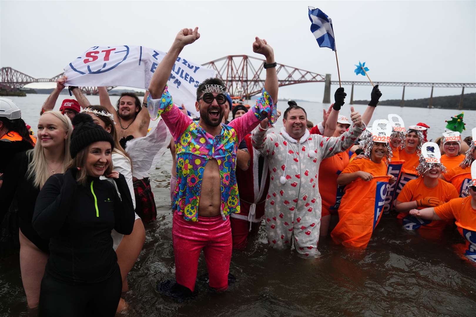 Revellers at the Loony Dook New Year’s Day dip in the Firth of Forth (Andrew Milligan/PA)