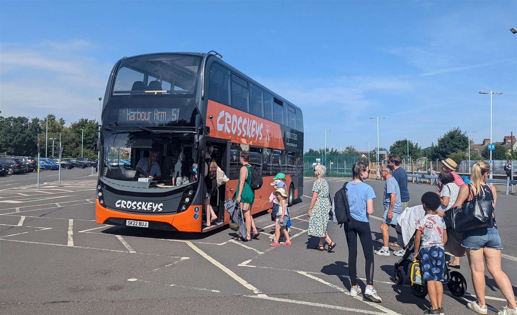 Day-trippers hopping on the free bus to the beach at Folkestone West