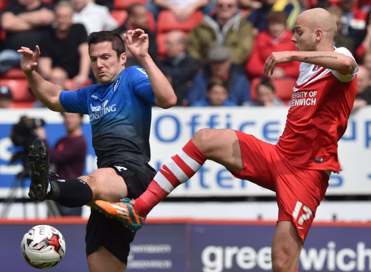 Charlton's Yoni Buyens challenges with Bournemouth's former Addicks forward Yann Kermorgant. Picture: Keith Gillard