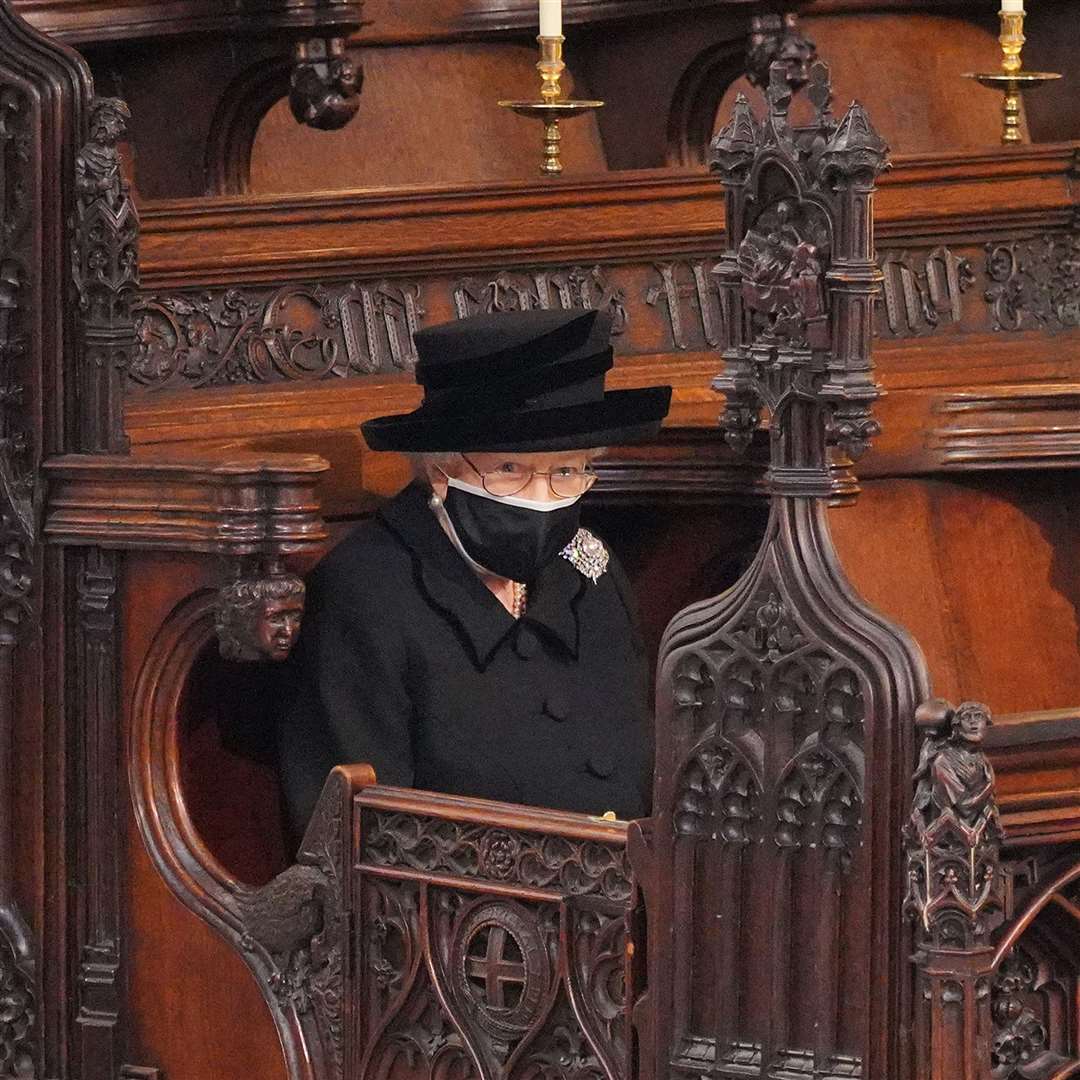 The Queen taking her seat alone for the funeral of the Duke of Edinburgh’s funeral in St George’s Chapel (Jonathan Brady/PA)