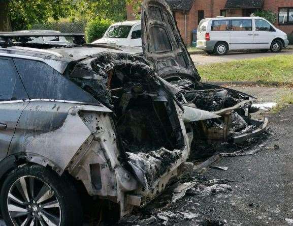 Two of the burned vehicles in Honfleur Road, Sandwich. Pictures: Dean Marie