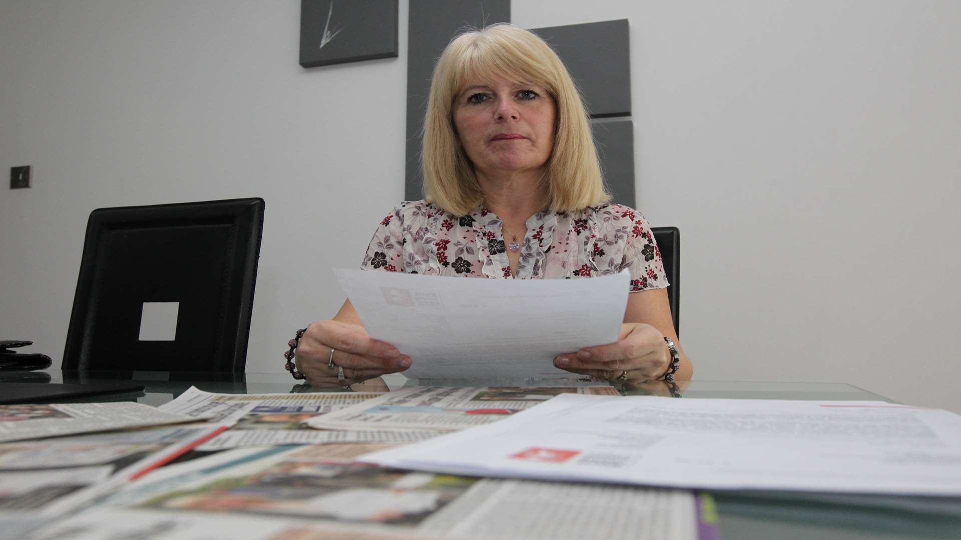 Tina Brooker with paper work she has collected from her correspondence with the KCC and the press