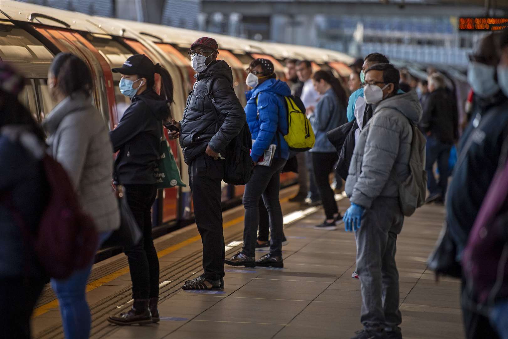 Passengers wearing face masks on a platform at Canning Town underground station in London (Victoria Jones/PA Wire)