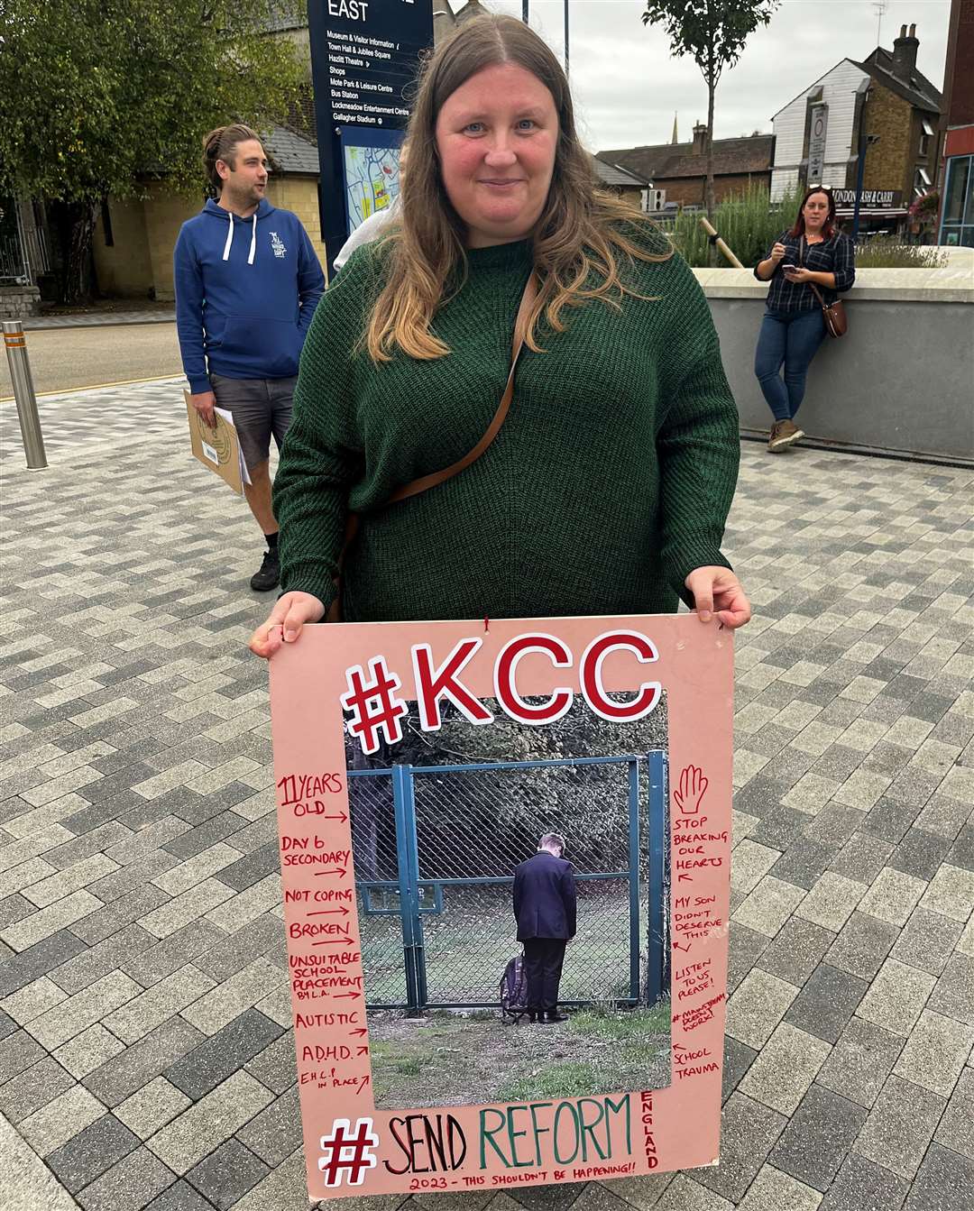 Sam from Folkestone holds a banner of her son Nathan on his sixth day of attending Year 7 mainstream secondary school