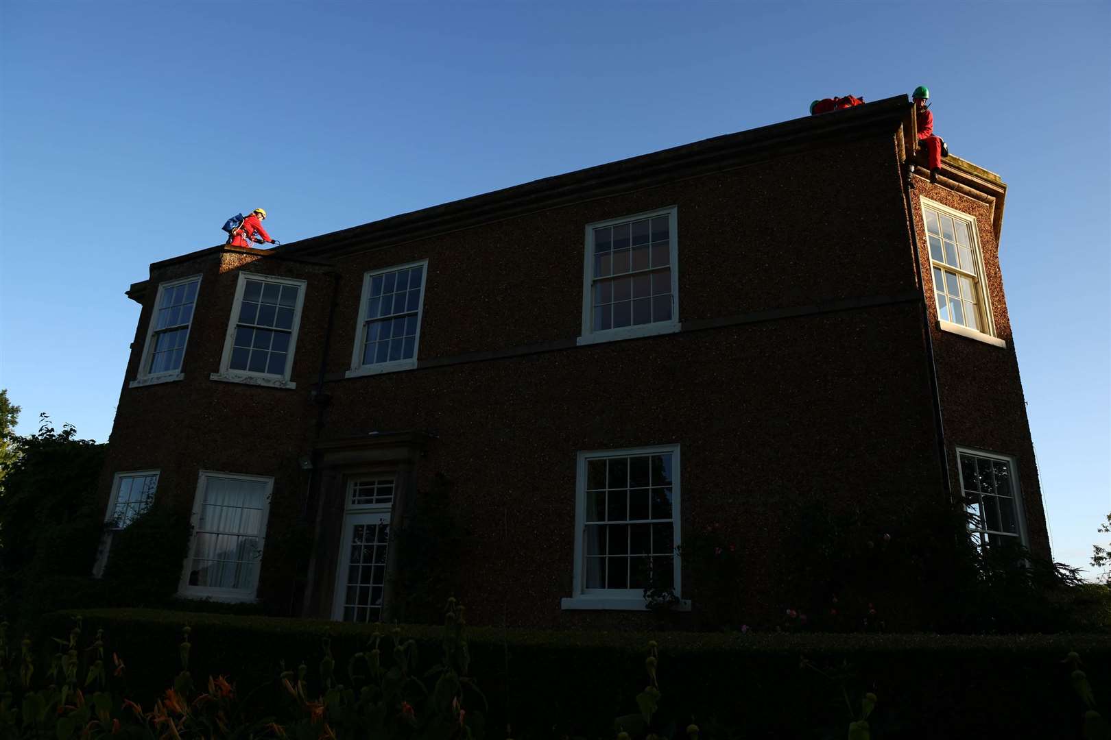 Greenpeace activists climbing on the roof of the Prime Minister’s house in North Yorkshire (Luca Marino/Greenpeace/PA)