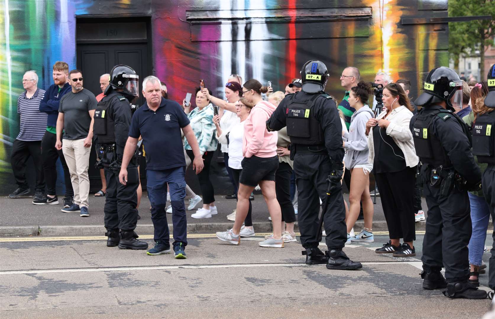 Gerard Rice, Lower Ormeau Residents spokesman, tries to defuse the situation (Peter Morrison/PA)